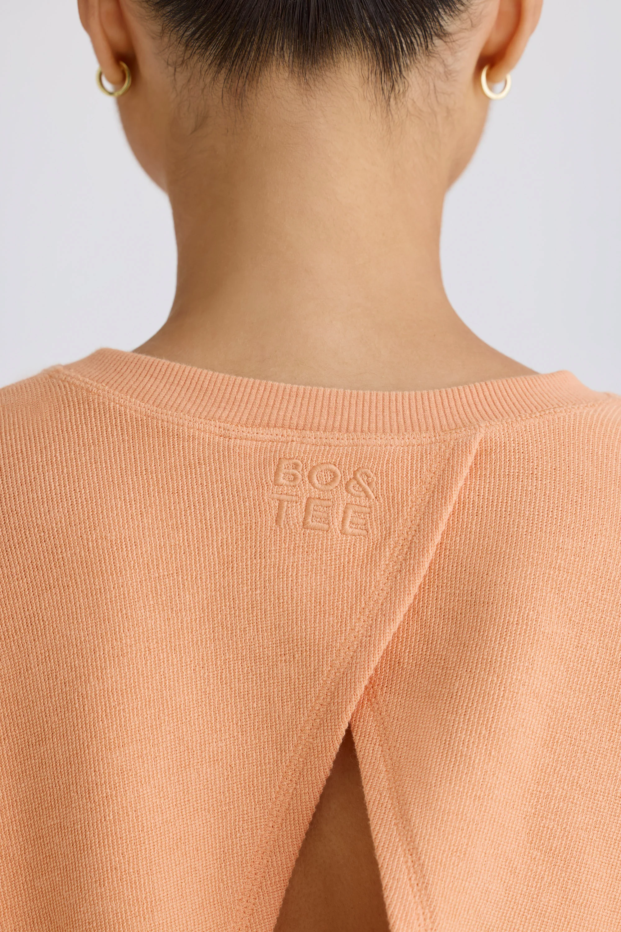 Textured Cotton Jersey Open-Back Cropped Sweatshirt in Peach