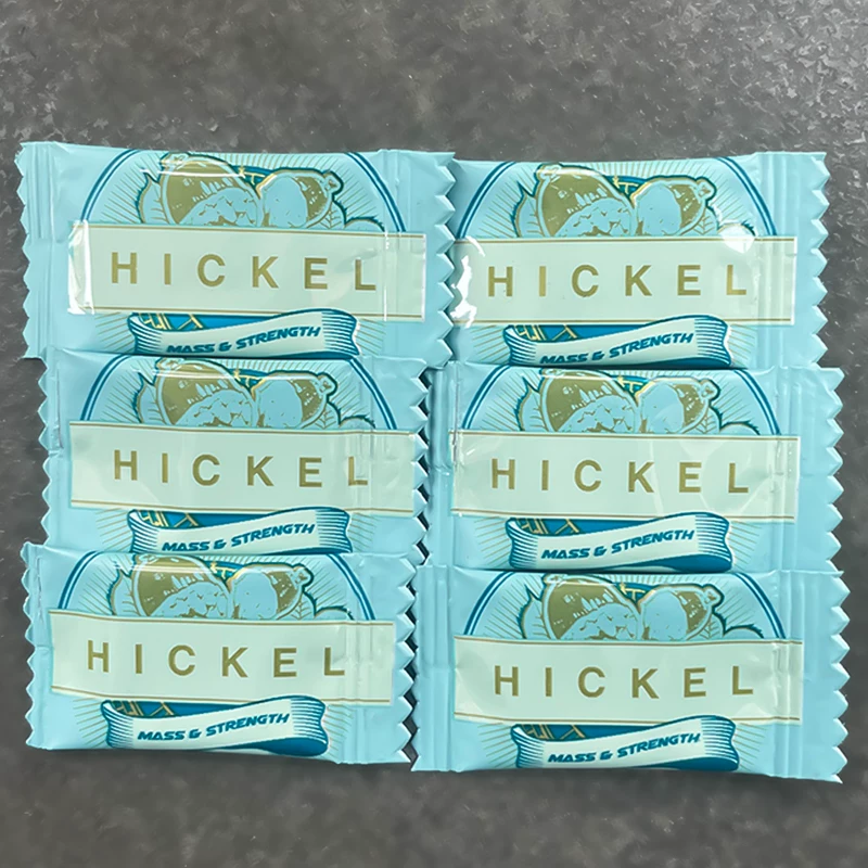 Six individually wrapped blue HICKEL bars arranged on a dark surface