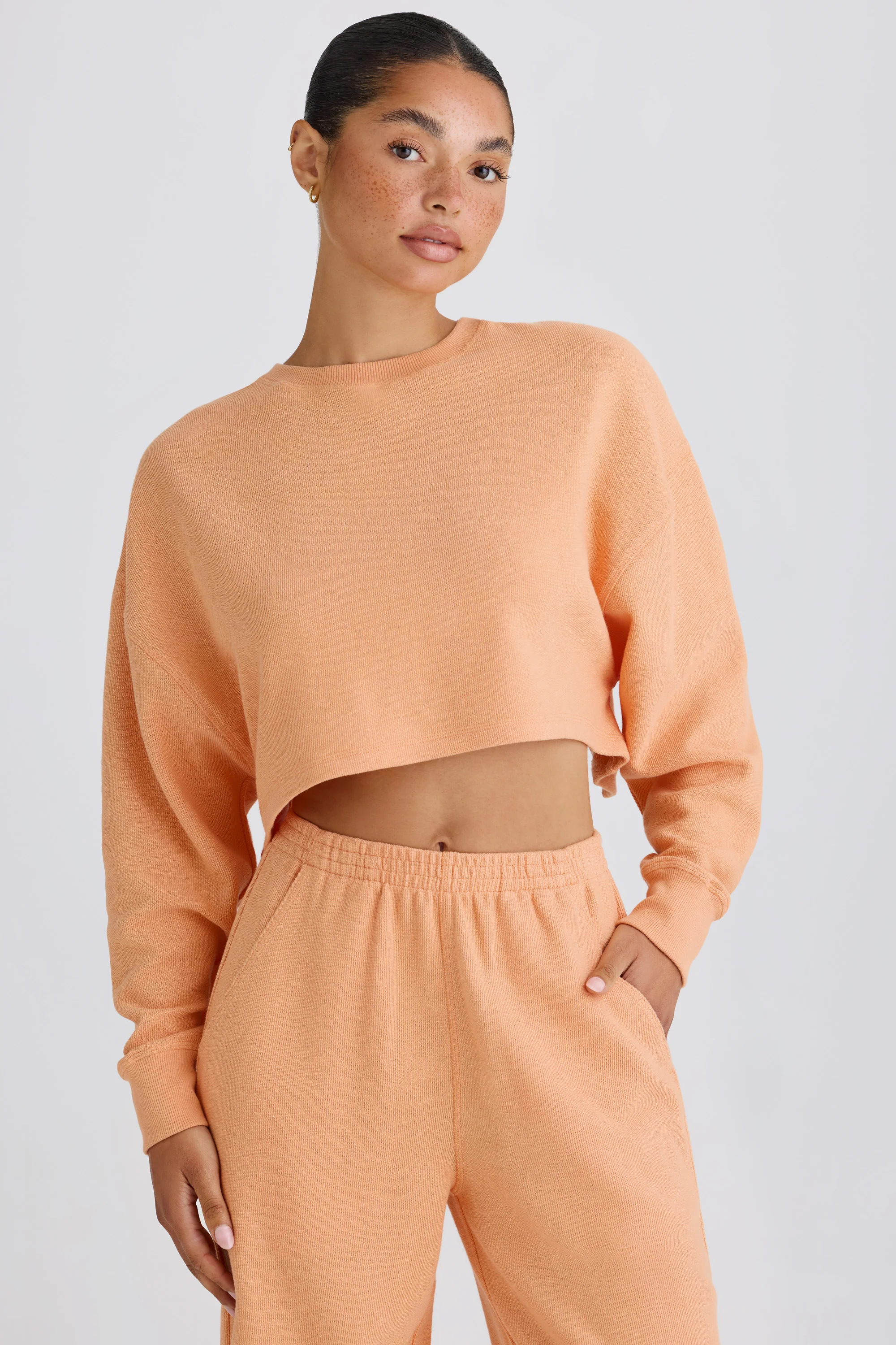 Textured Cotton Jersey Open-Back Cropped Sweatshirt in Peach