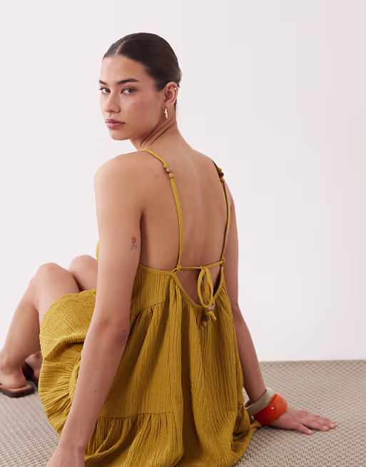 textured halter trapeze mini dress in ocre