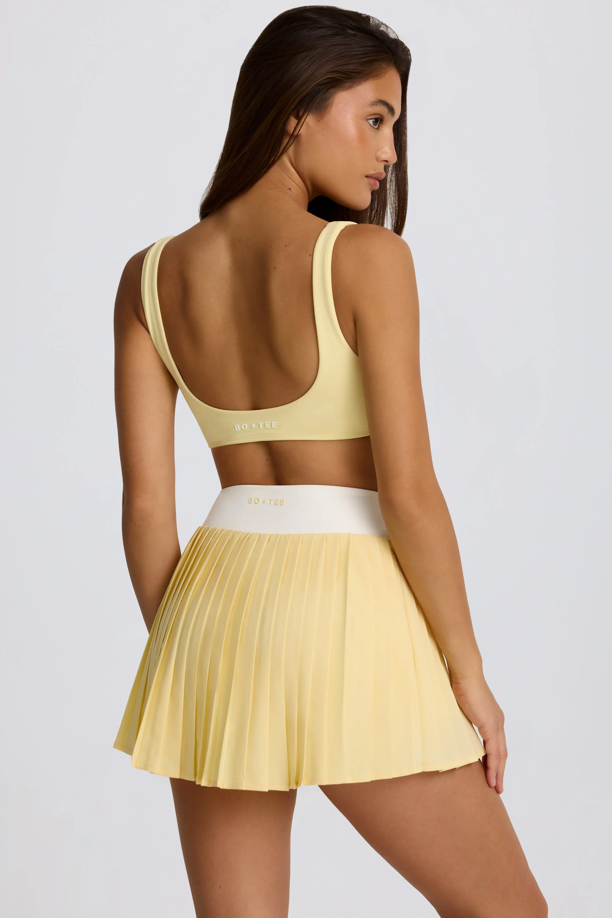 Soft Active Crossover Pleated Mini Skort in Lemon