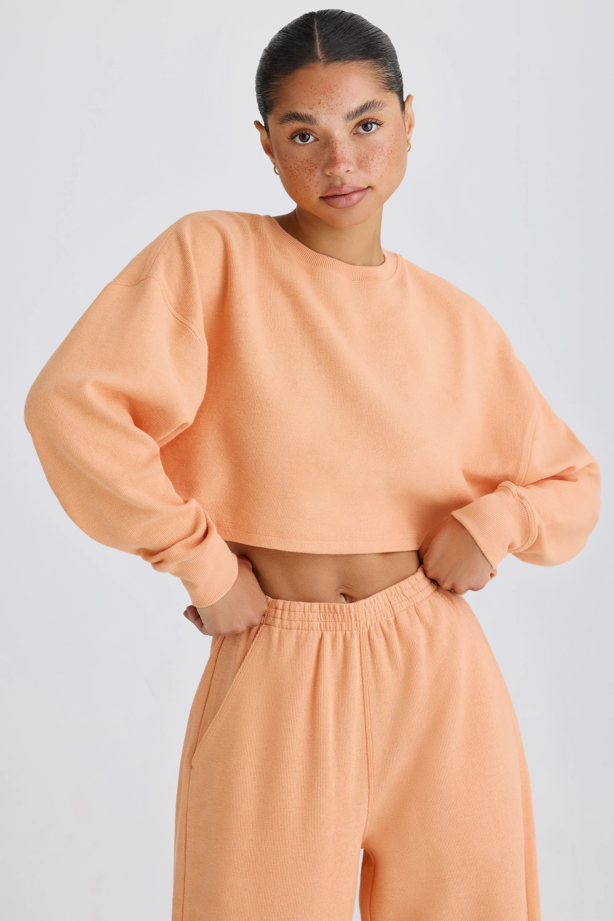 Textured Cotton Jersey Open-Back Cropped Sweatshirt in Peach