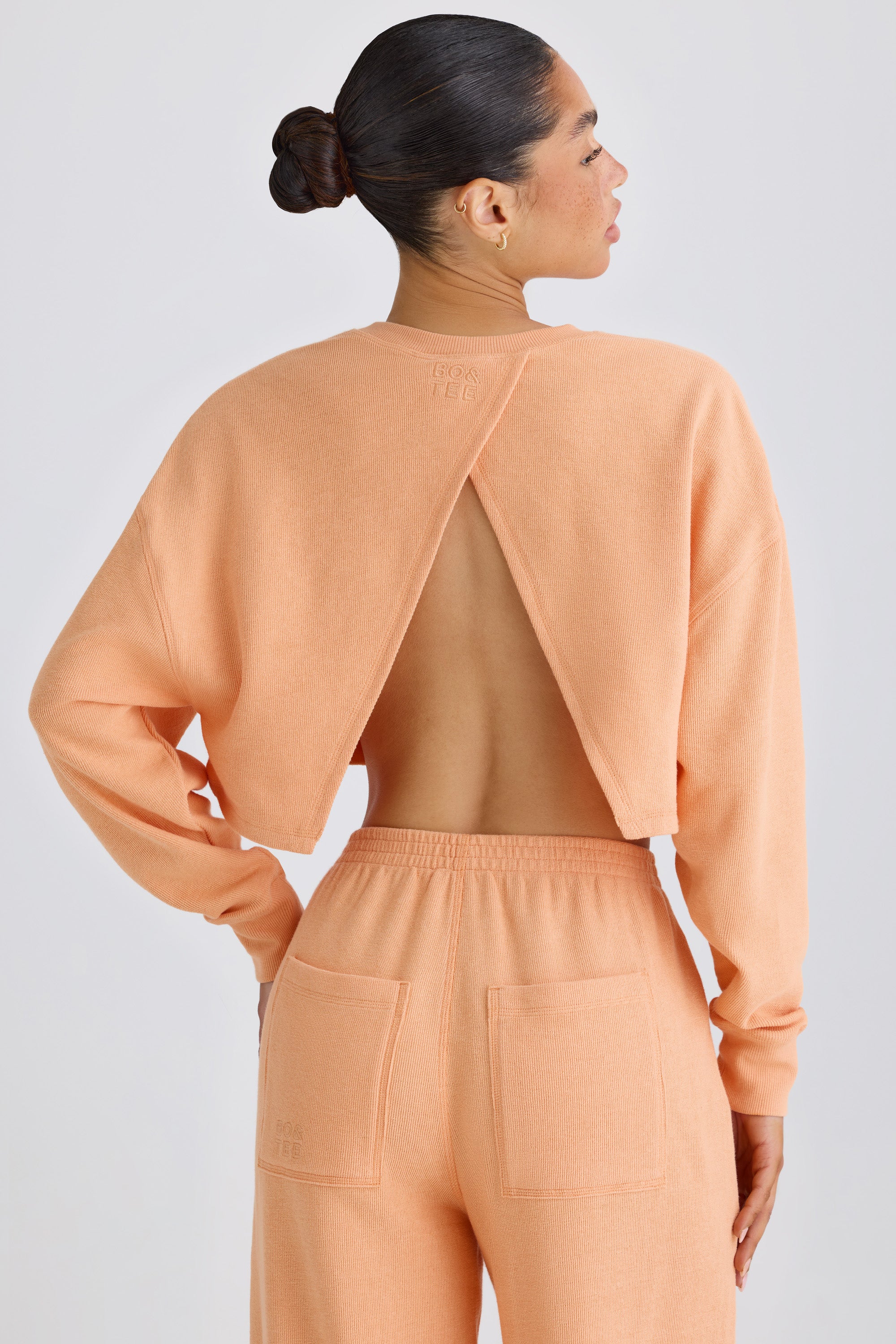Textured Cotton Jersey Open-Back Cropped Sweatshirt in Peach