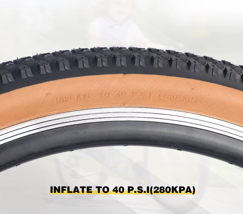 Close-up of foldable mountain bike tire with black tread and tan sidewall, marked with recommended inflation pressure up to 40 PSI (280 KPA), suitable for mountain bikes, standard bicycles, and electric bikes. 🚴