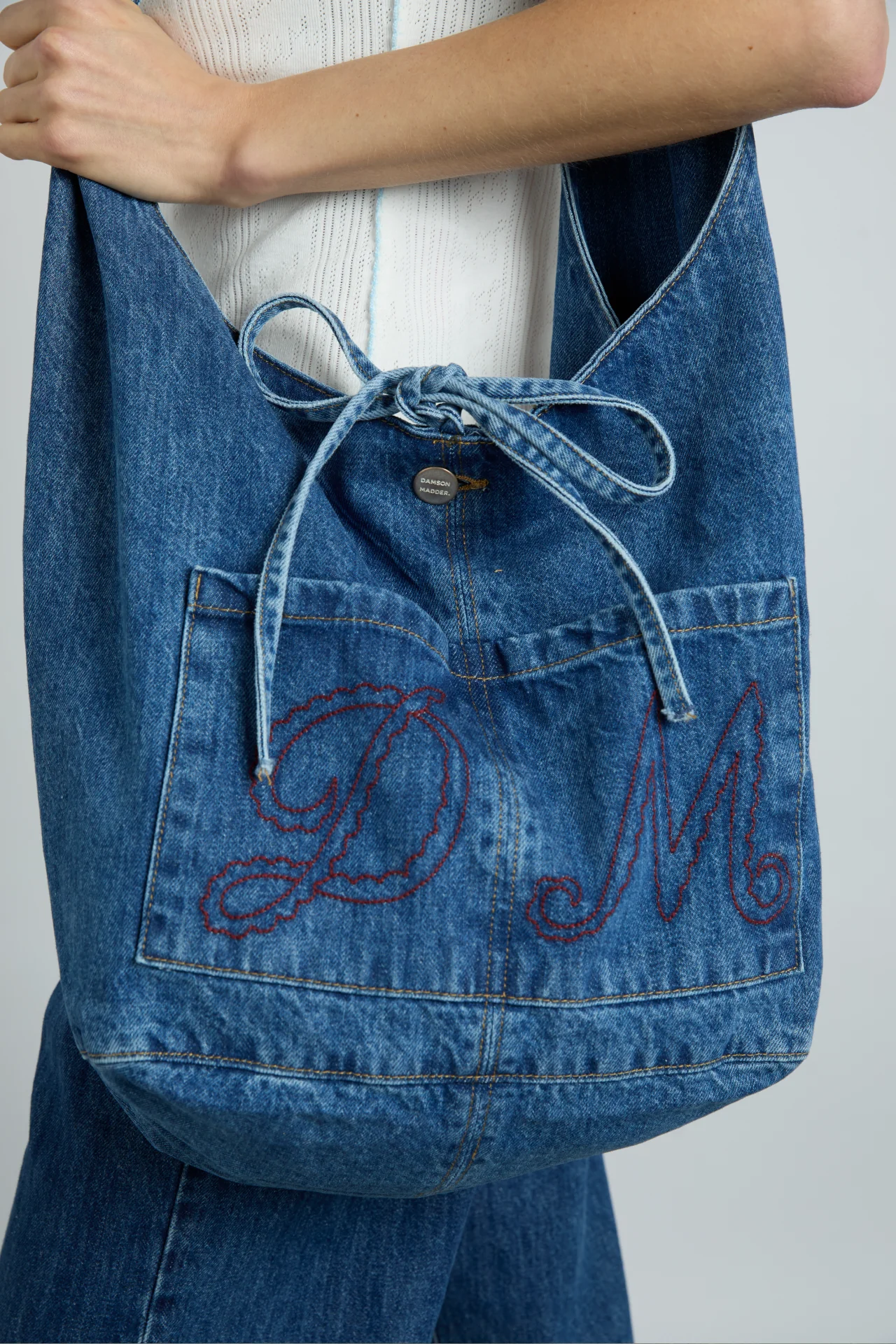 denim sling bag with pocket detail