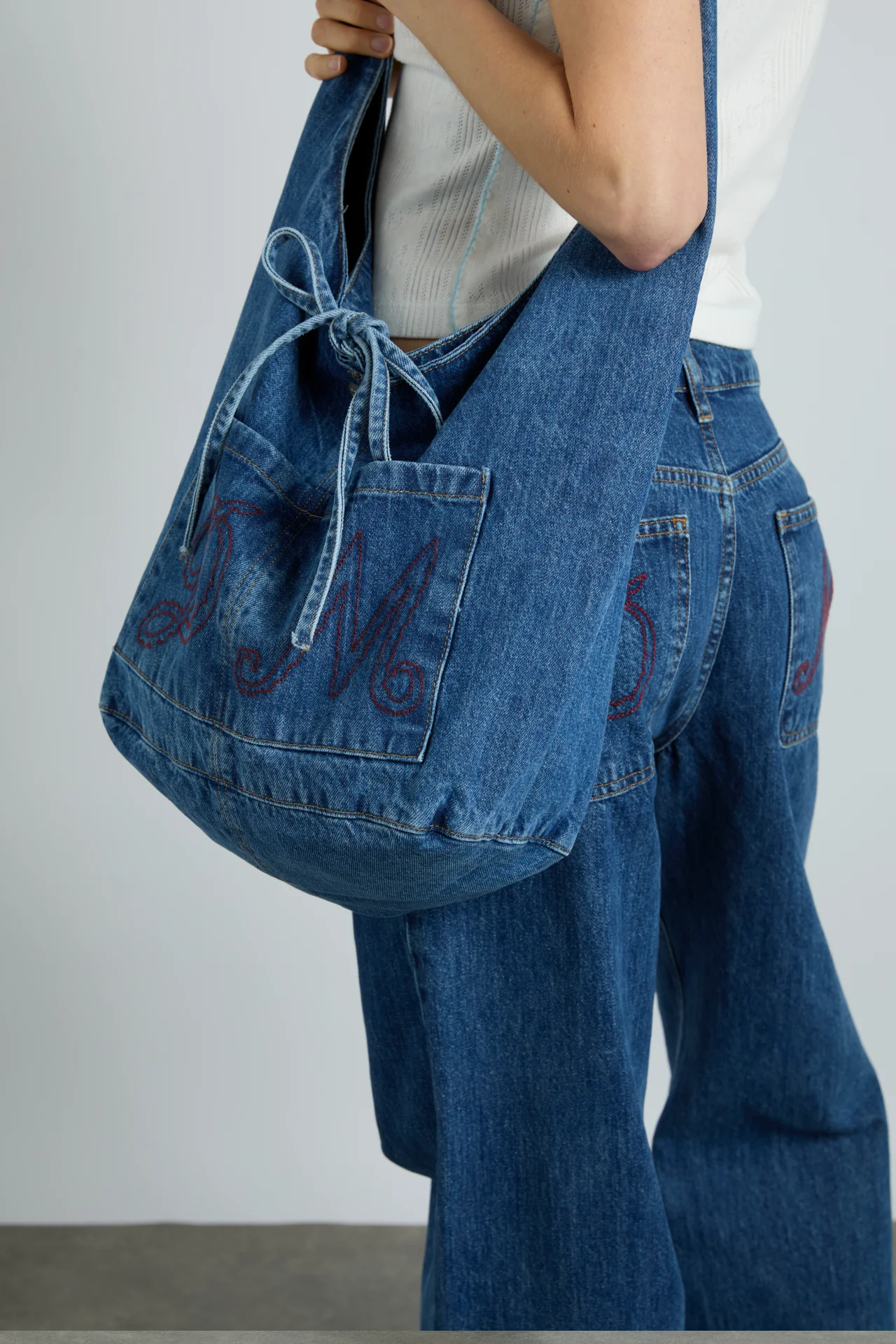 denim sling bag with pocket detail