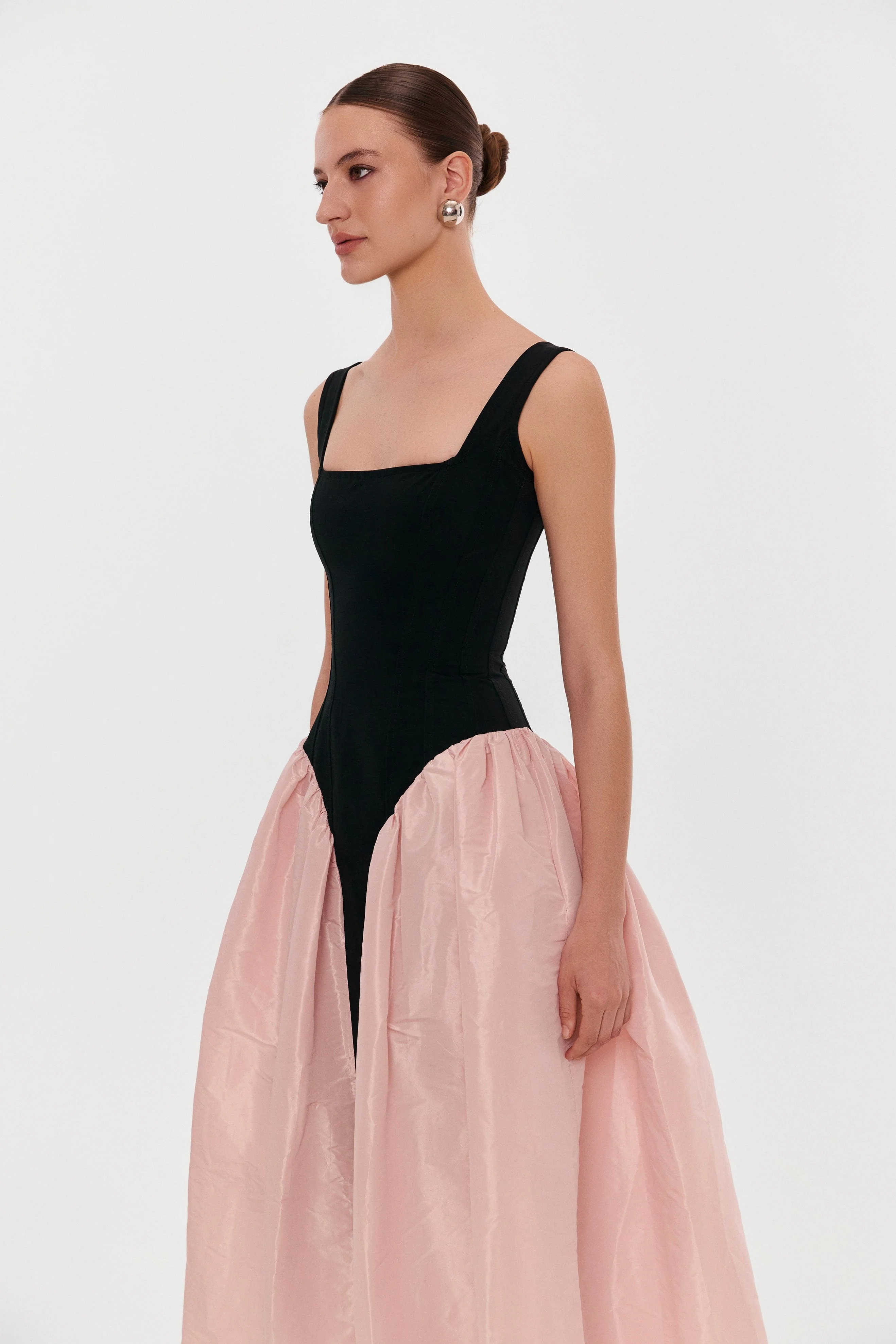 Black corset dress on straps with a glossy pink midi skirt