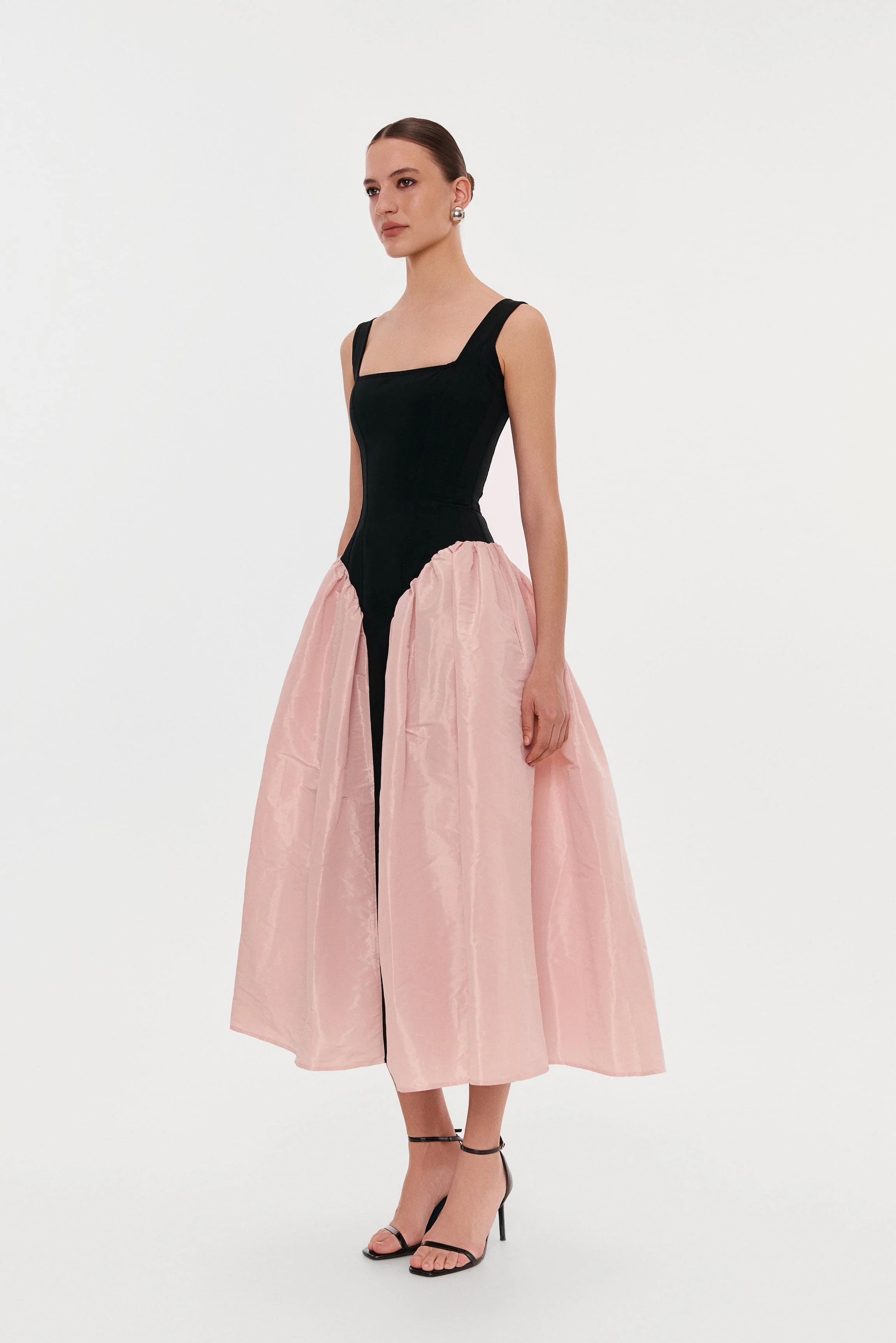 Black corset dress on straps with a glossy pink midi skirt