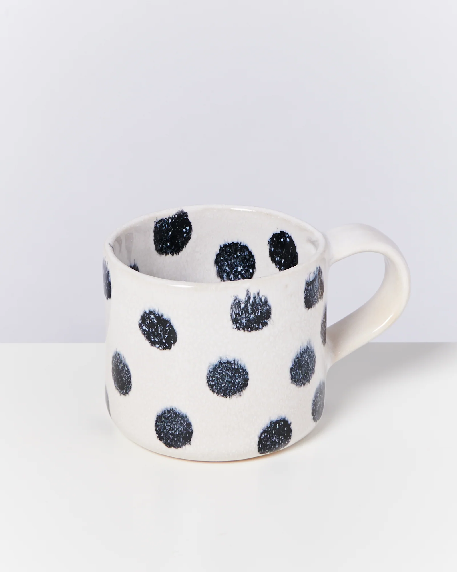 Nódoa Tasse schwarze Punkte
