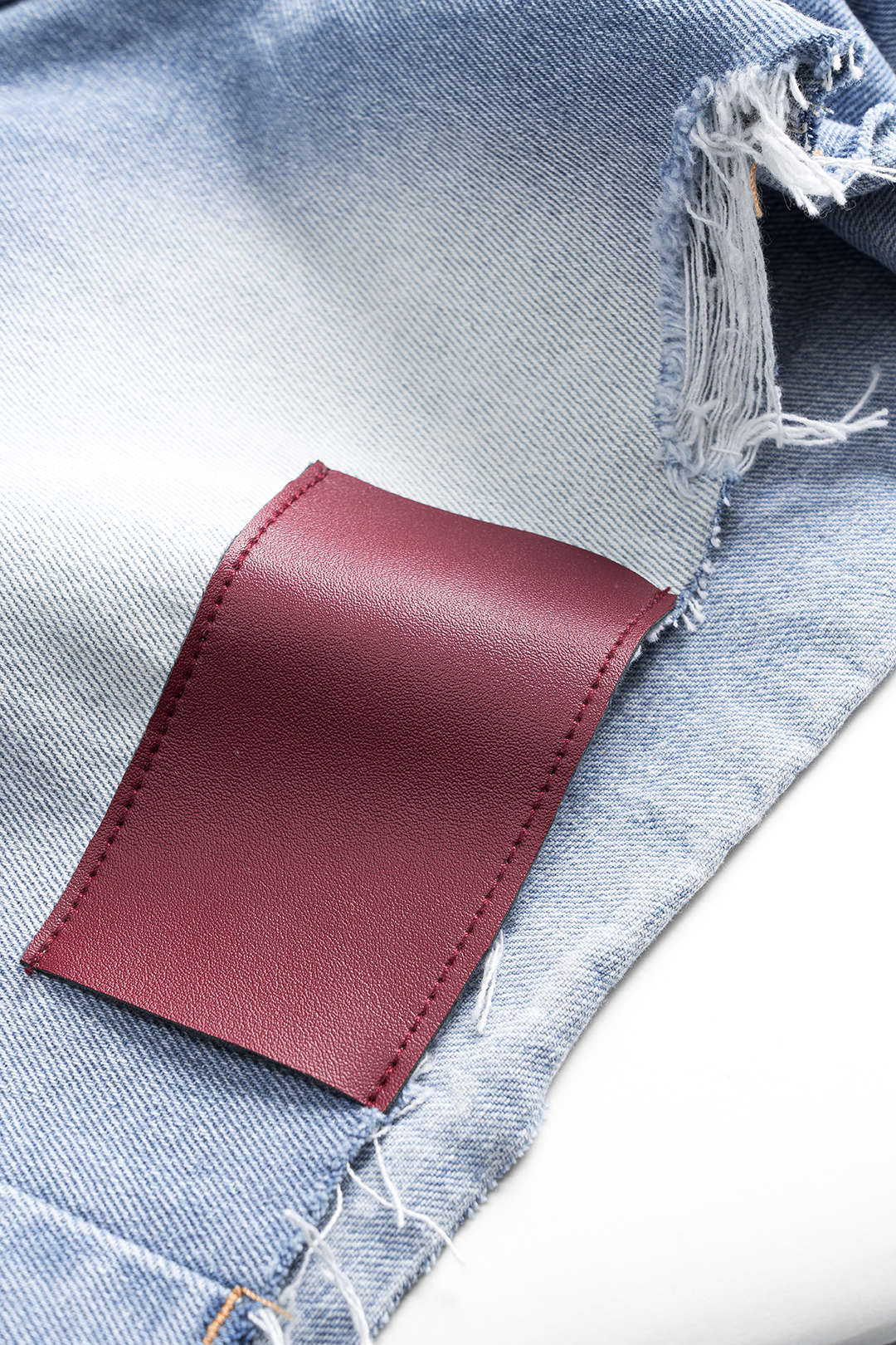 Asymmetrical Button Pocket Ripped Denim Shorts