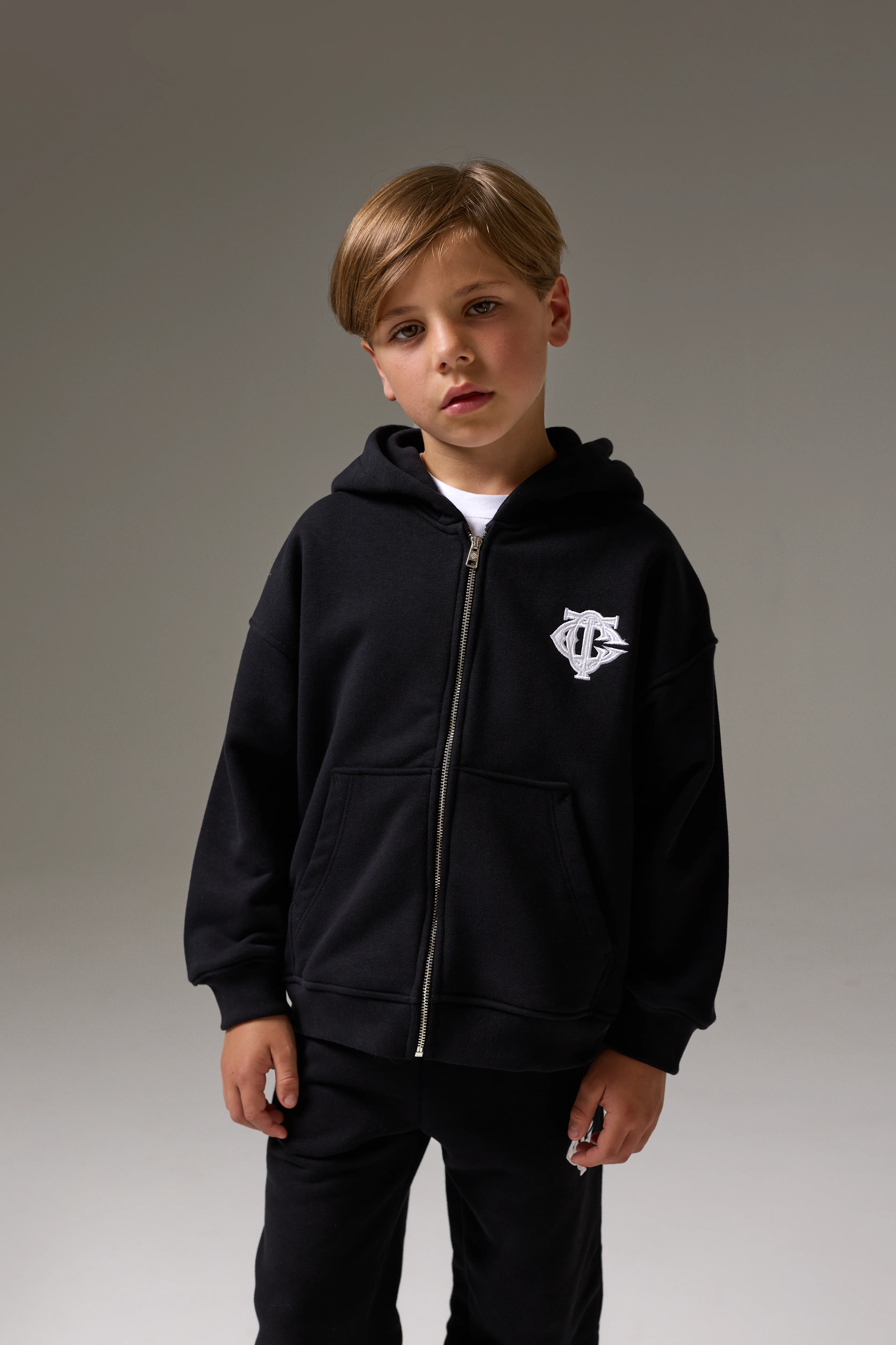 JUNIOR ZIP THROUGH MONOGRAM EMBLEM APPLIQUE HOODIE - BLACK