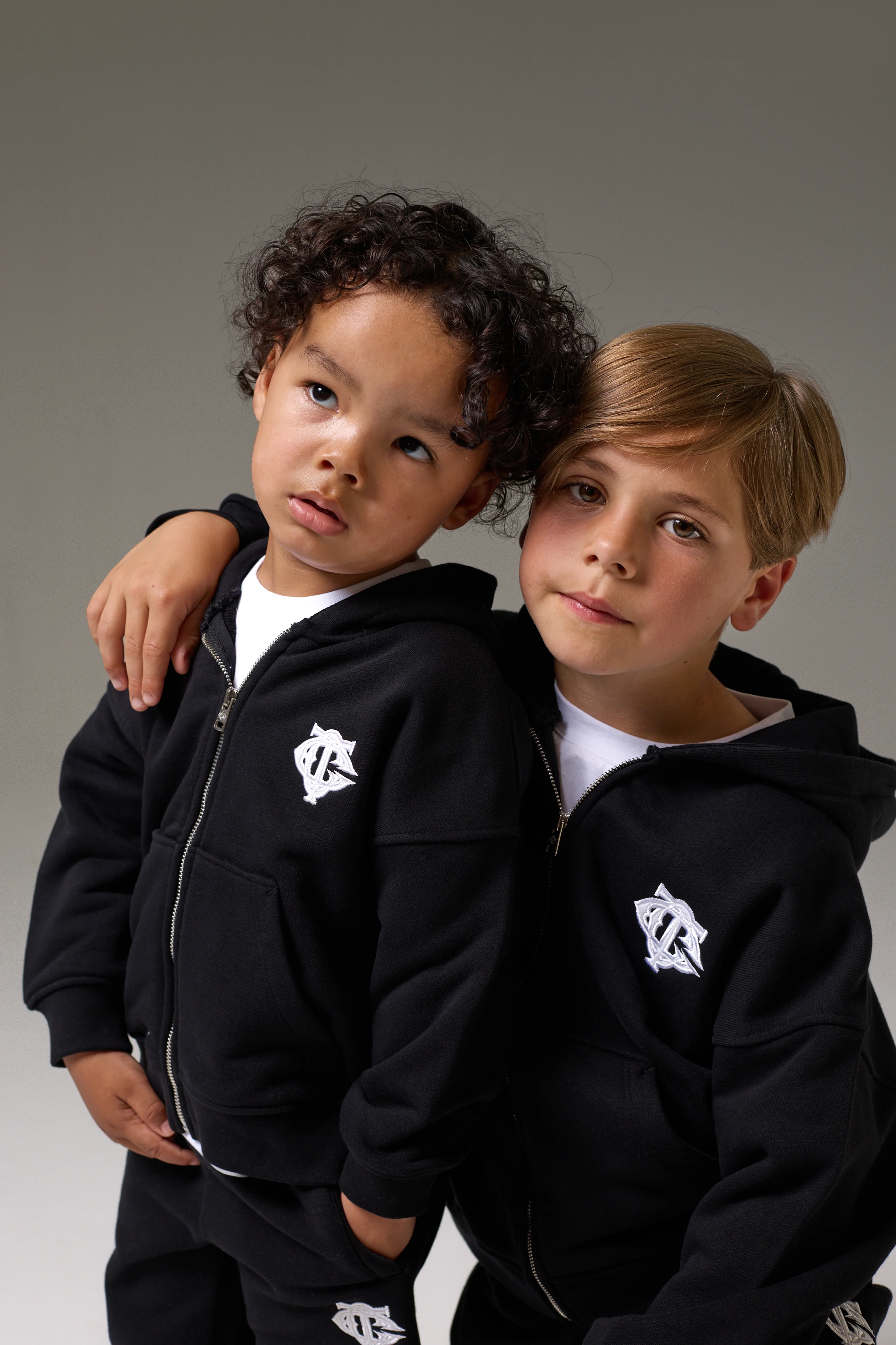 JUNIOR ZIP THROUGH MONOGRAM EMBLEM APPLIQUE HOODIE - BLACK