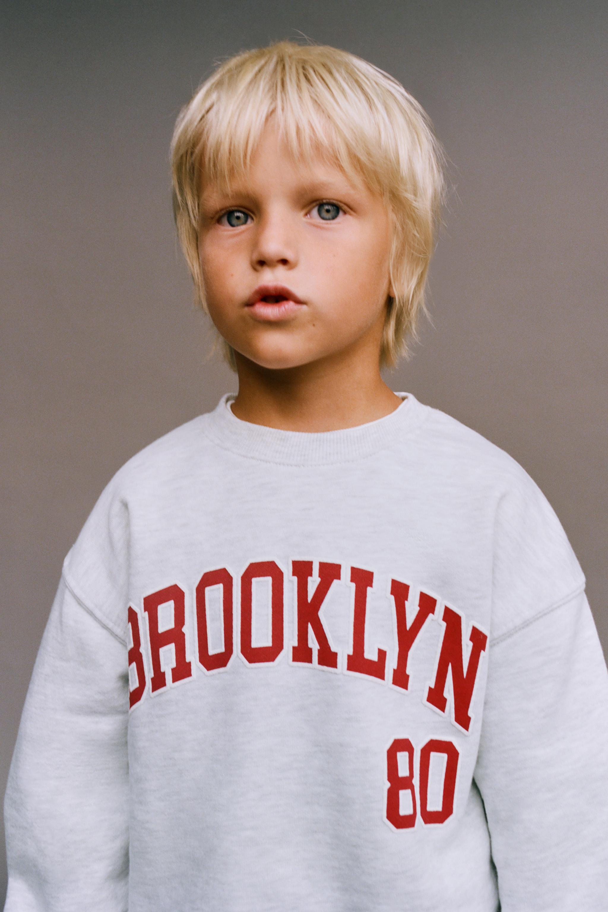 RAISED TEXT SWEATSHIRT