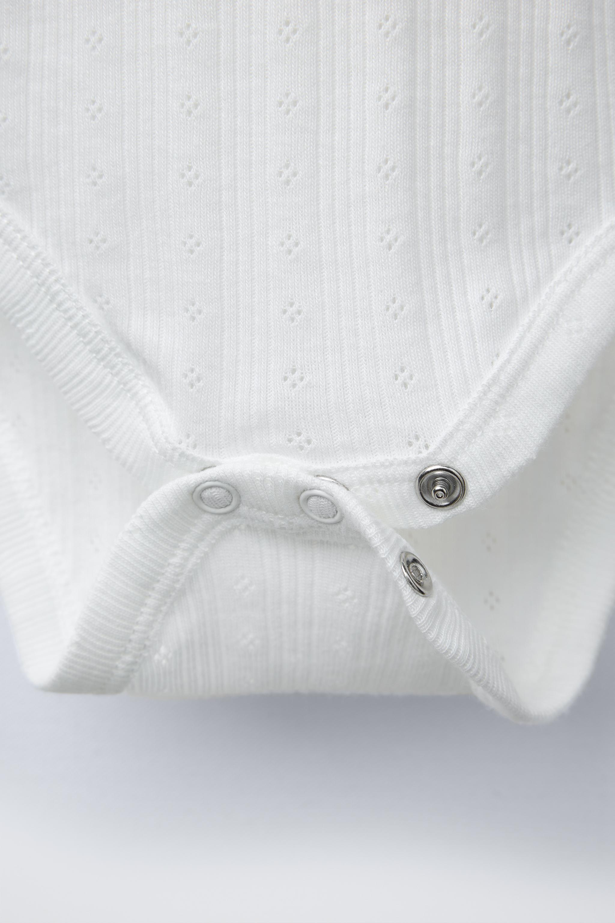 THREE-PACK OF RIB KNIT BODYSUITS WITH CUTOUT DETAIL