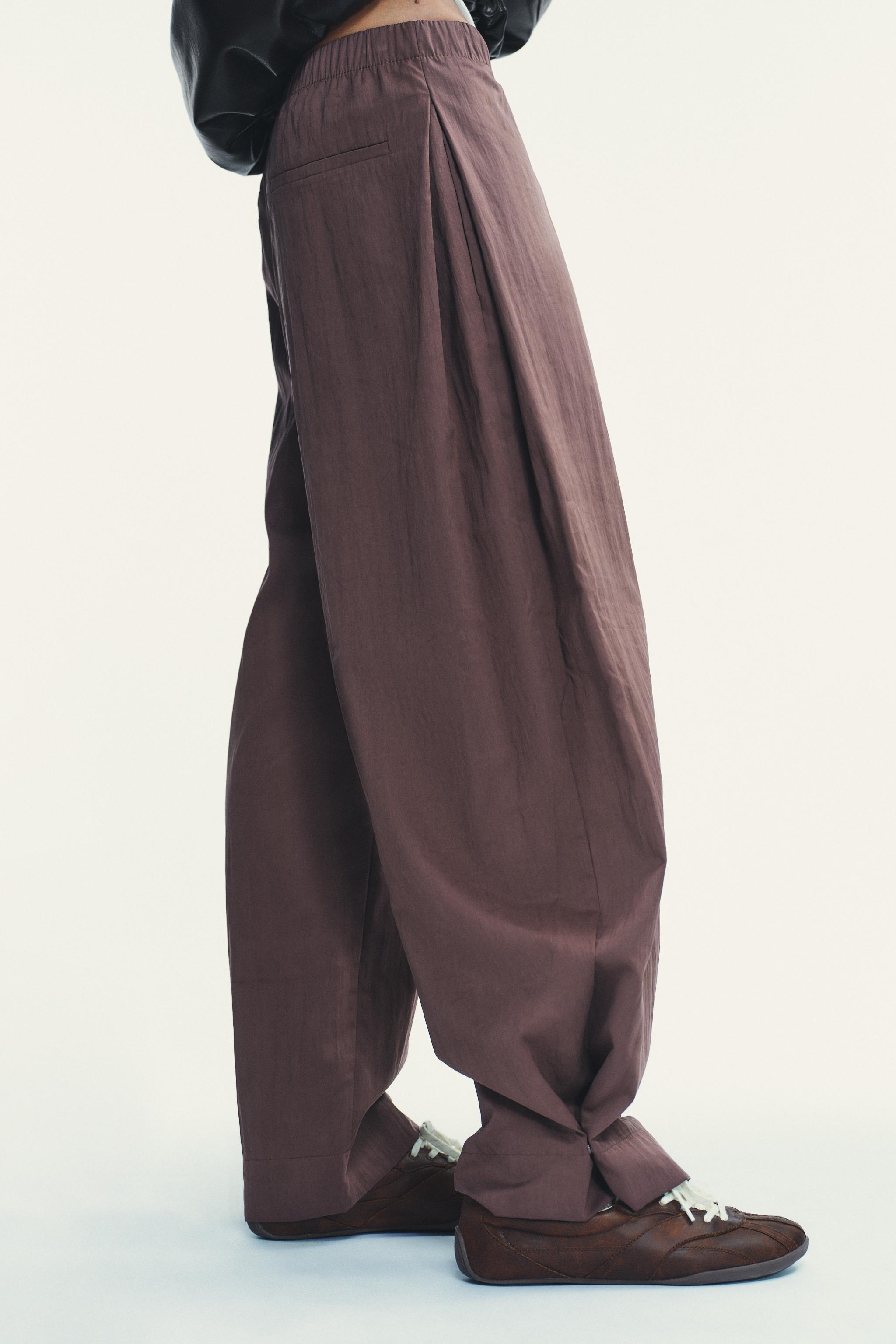 NYLON PANTS WITH BUTTON HEM