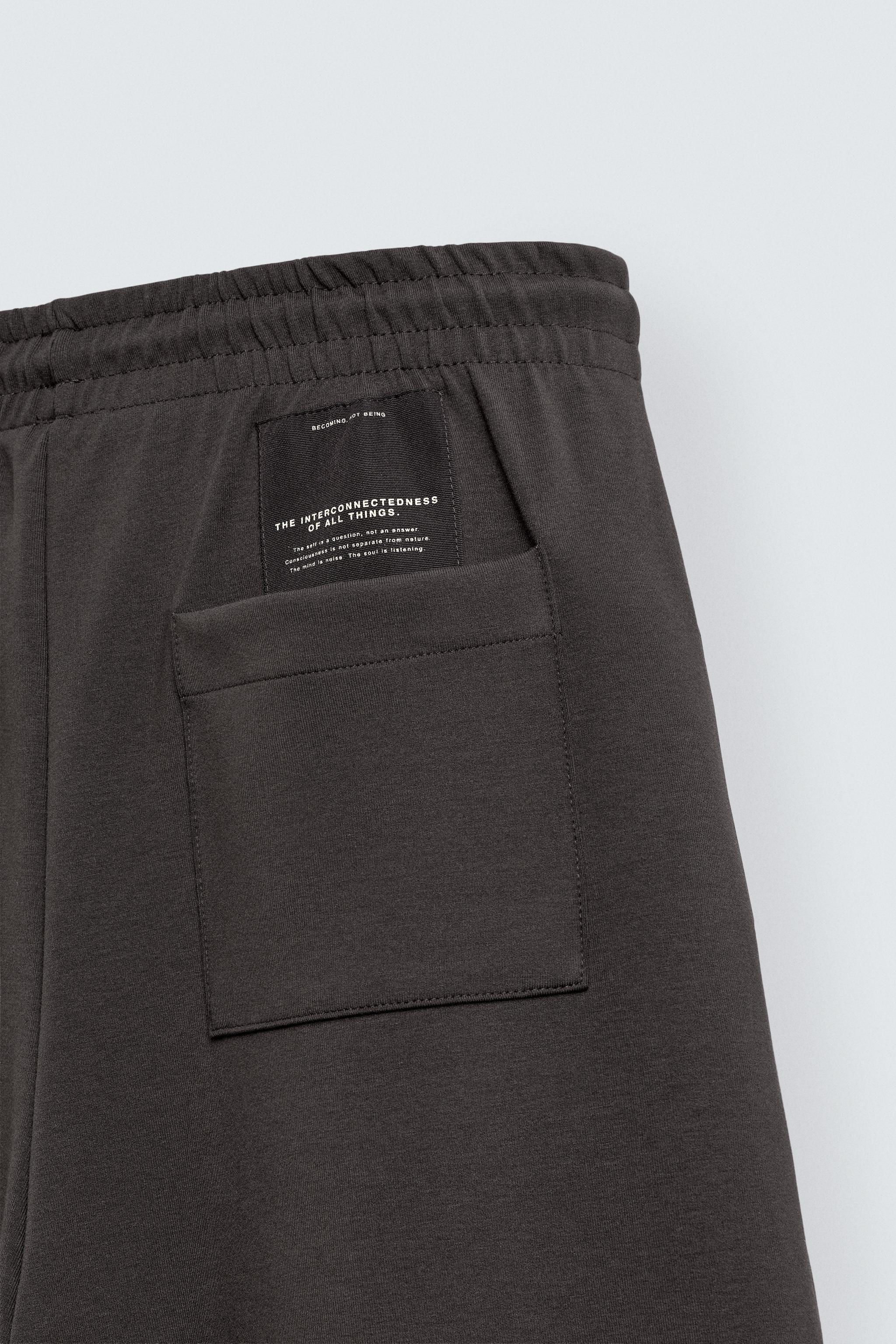 INTERLOCK PLEATED LABEL PANTS