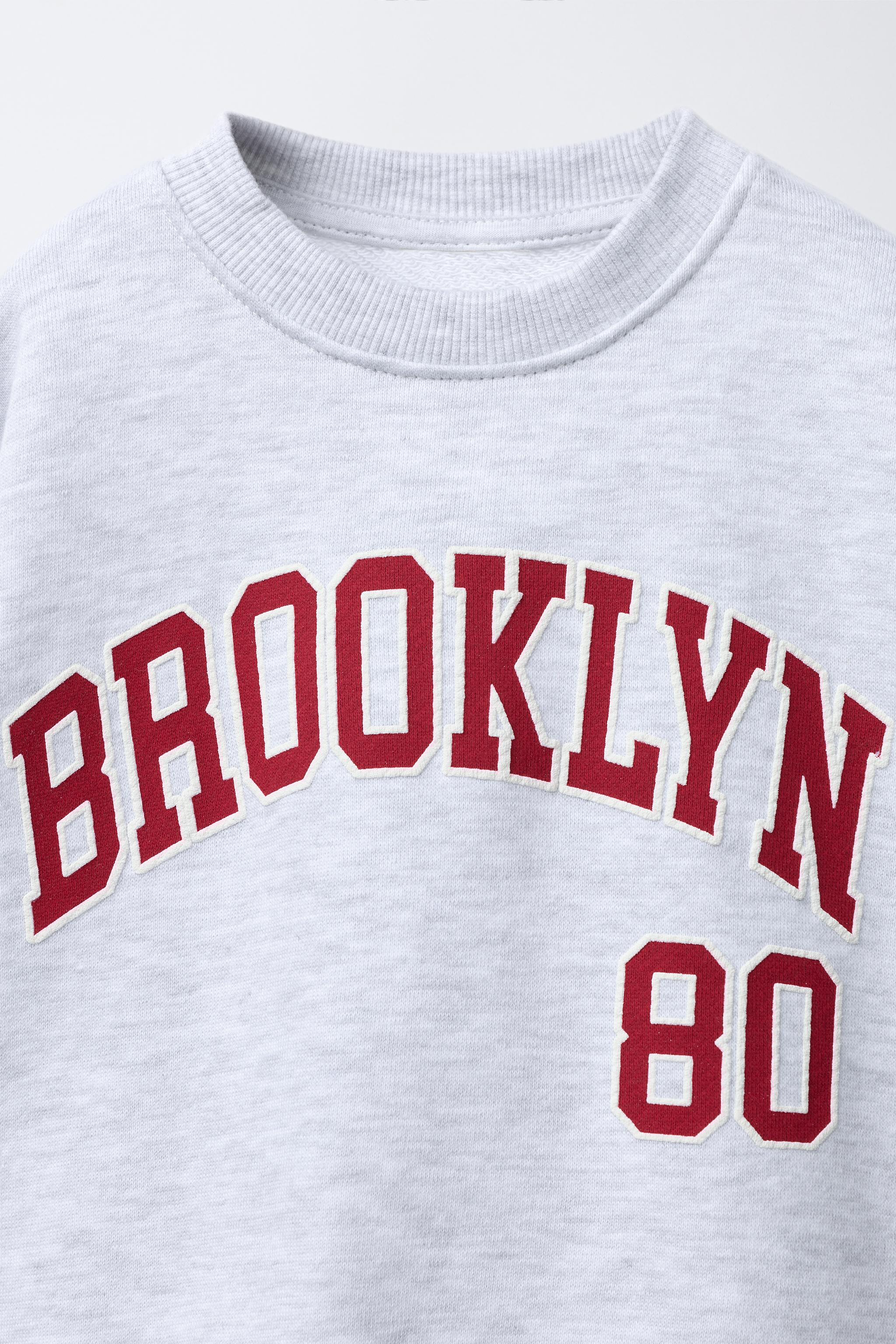 RAISED TEXT SWEATSHIRT