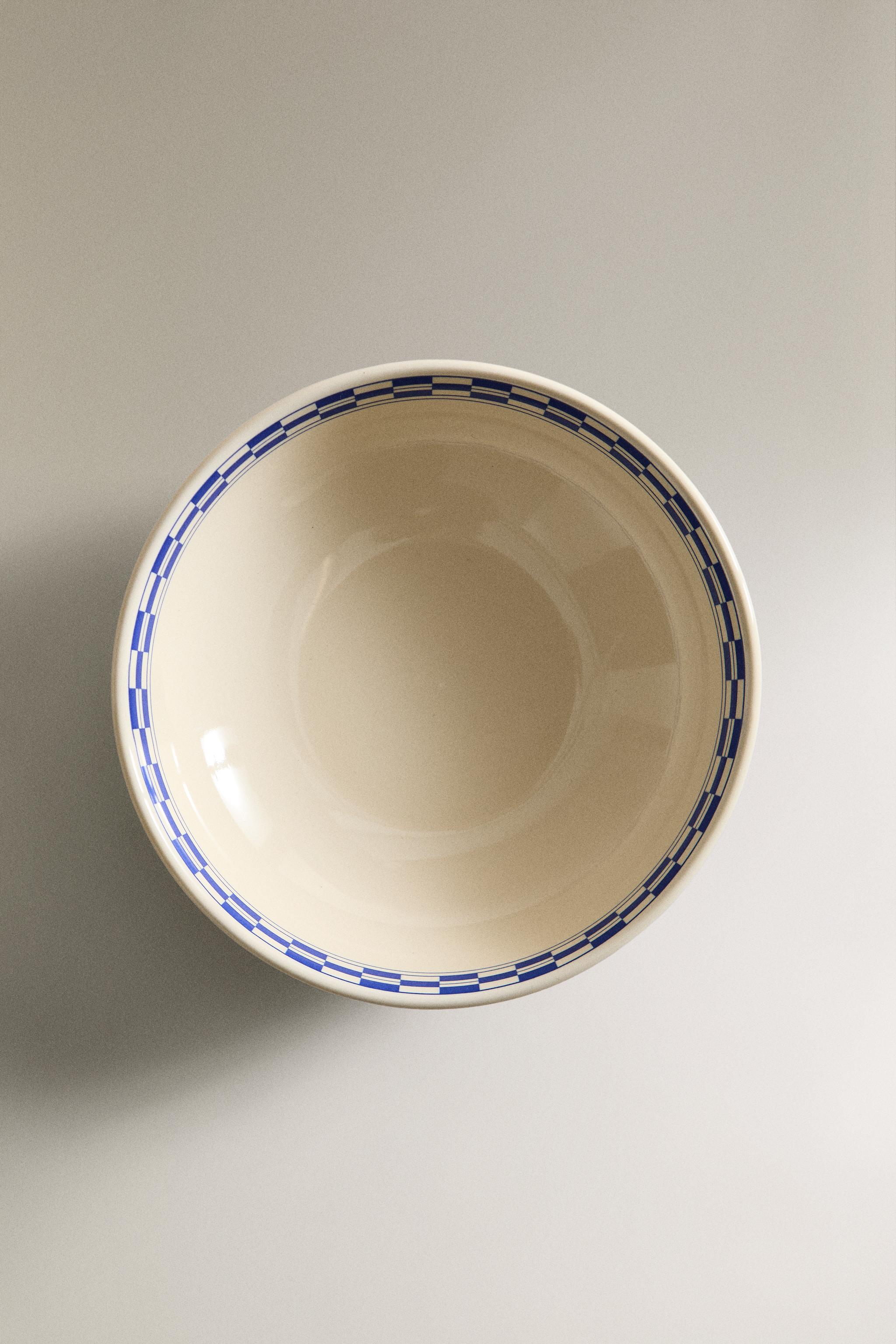 CERAMIC BOWL WITH A CHECKED DESIGN ON THE RIM