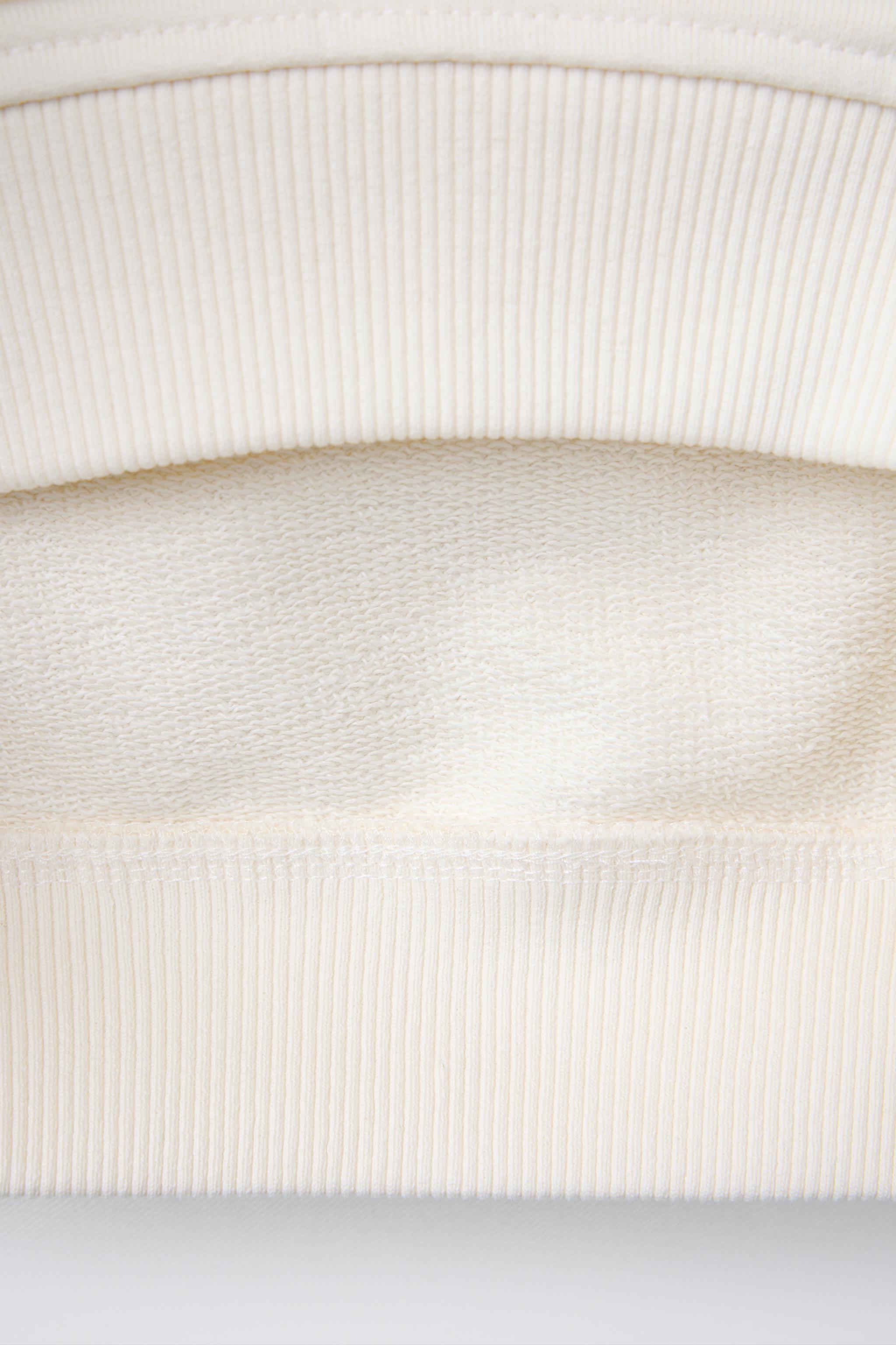 TOPSTITCHED RUFFLED SWEATSHIRT