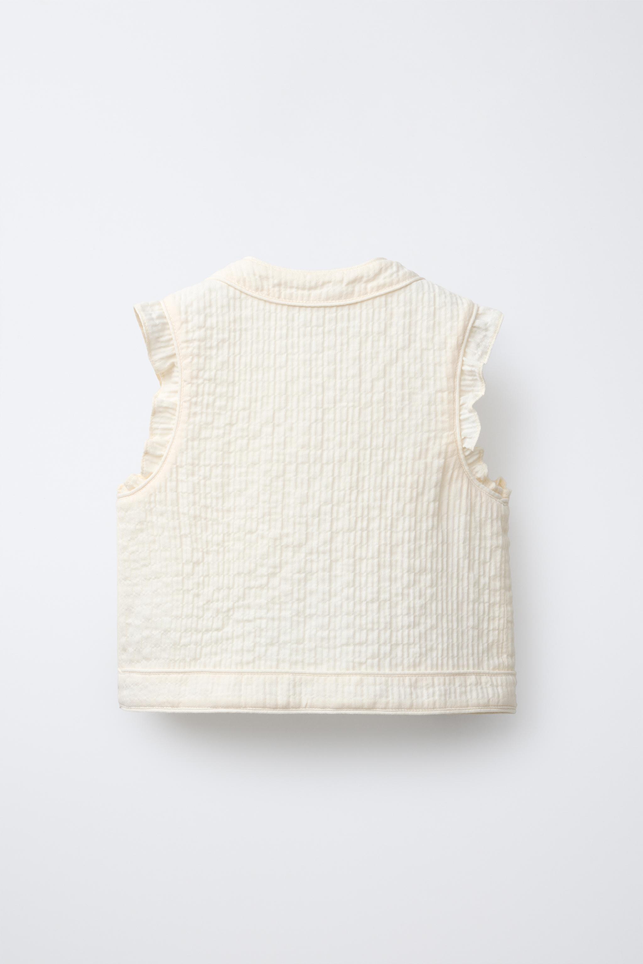 TEXTURED RUFFLE VEST