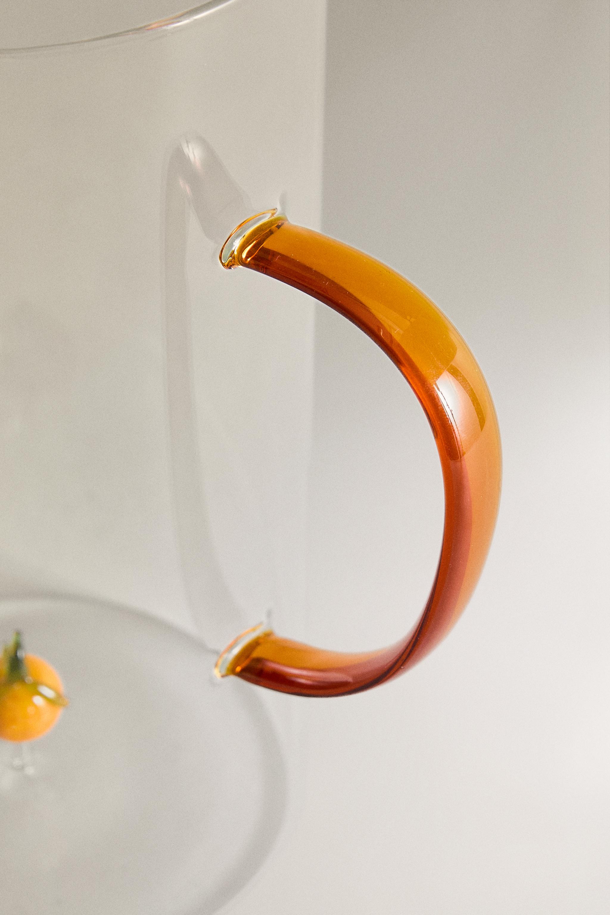 GLASS PITCHER WITH A HANDLE AND ORANGE DETAIL