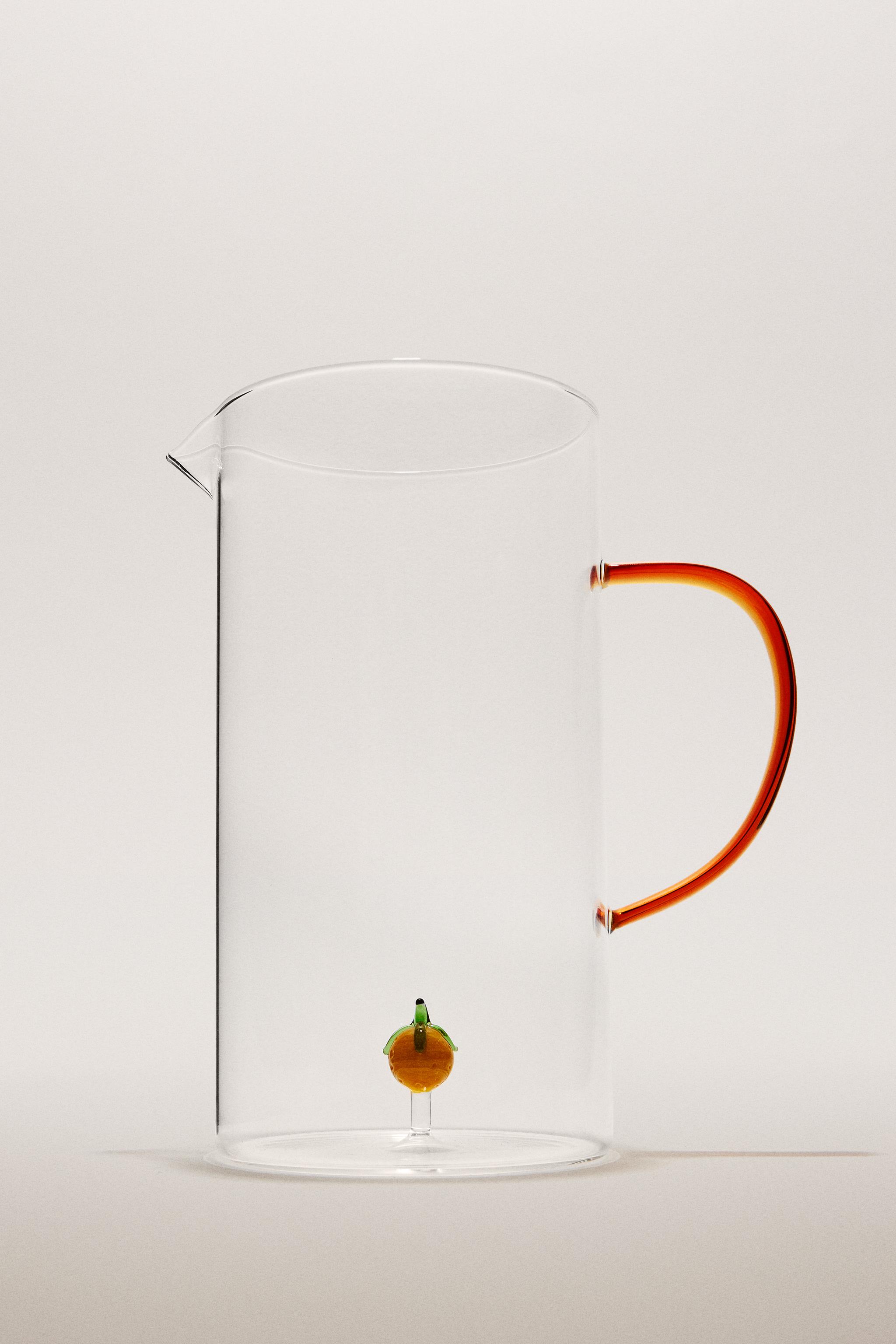 GLASS PITCHER WITH A HANDLE AND ORANGE DETAIL