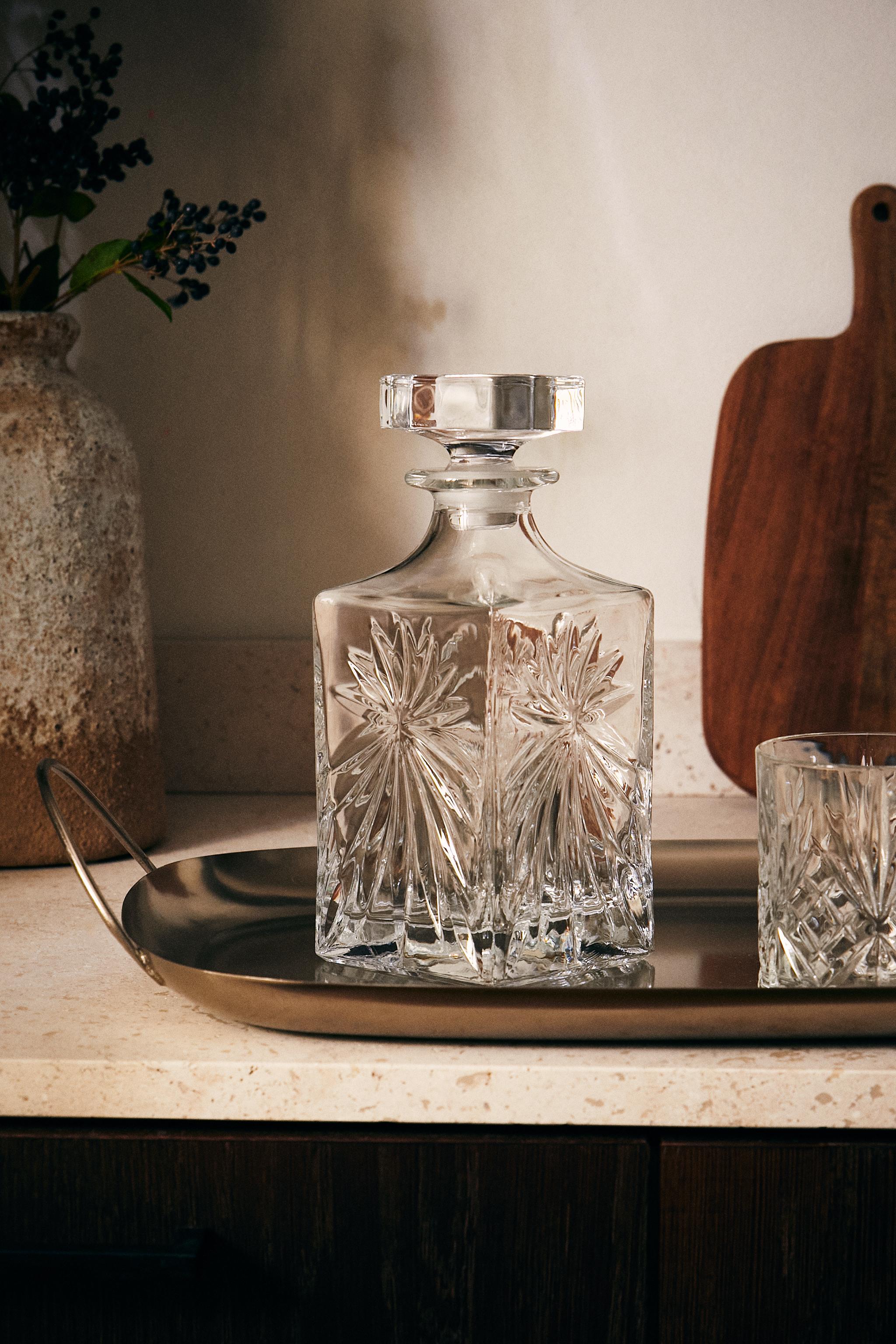 CRYSTALLINE BOTTLE WITH RAISED DESIGN