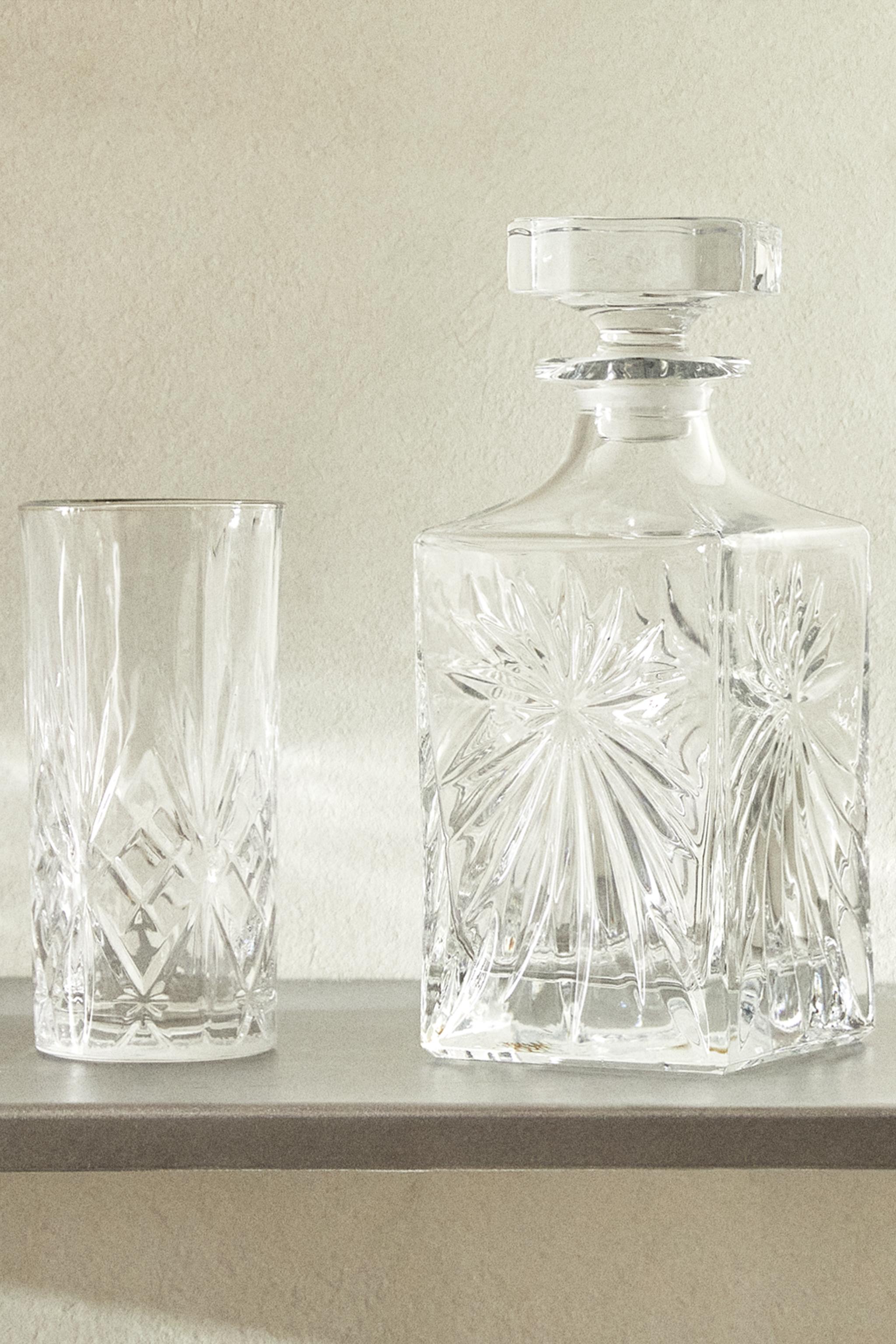 CRYSTALLINE BOTTLE WITH RAISED DESIGN