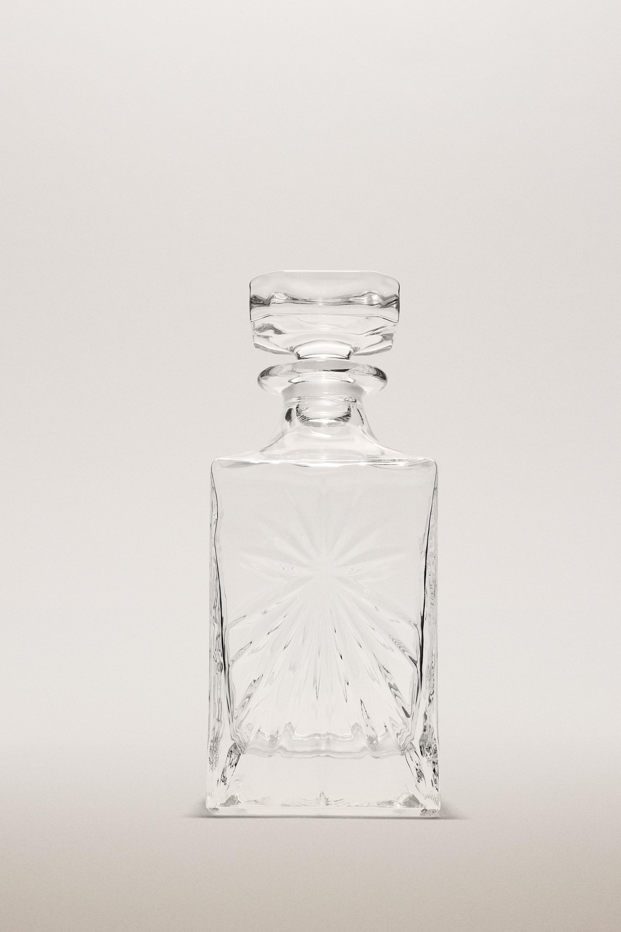 CRYSTALLINE BOTTLE WITH RAISED DESIGN