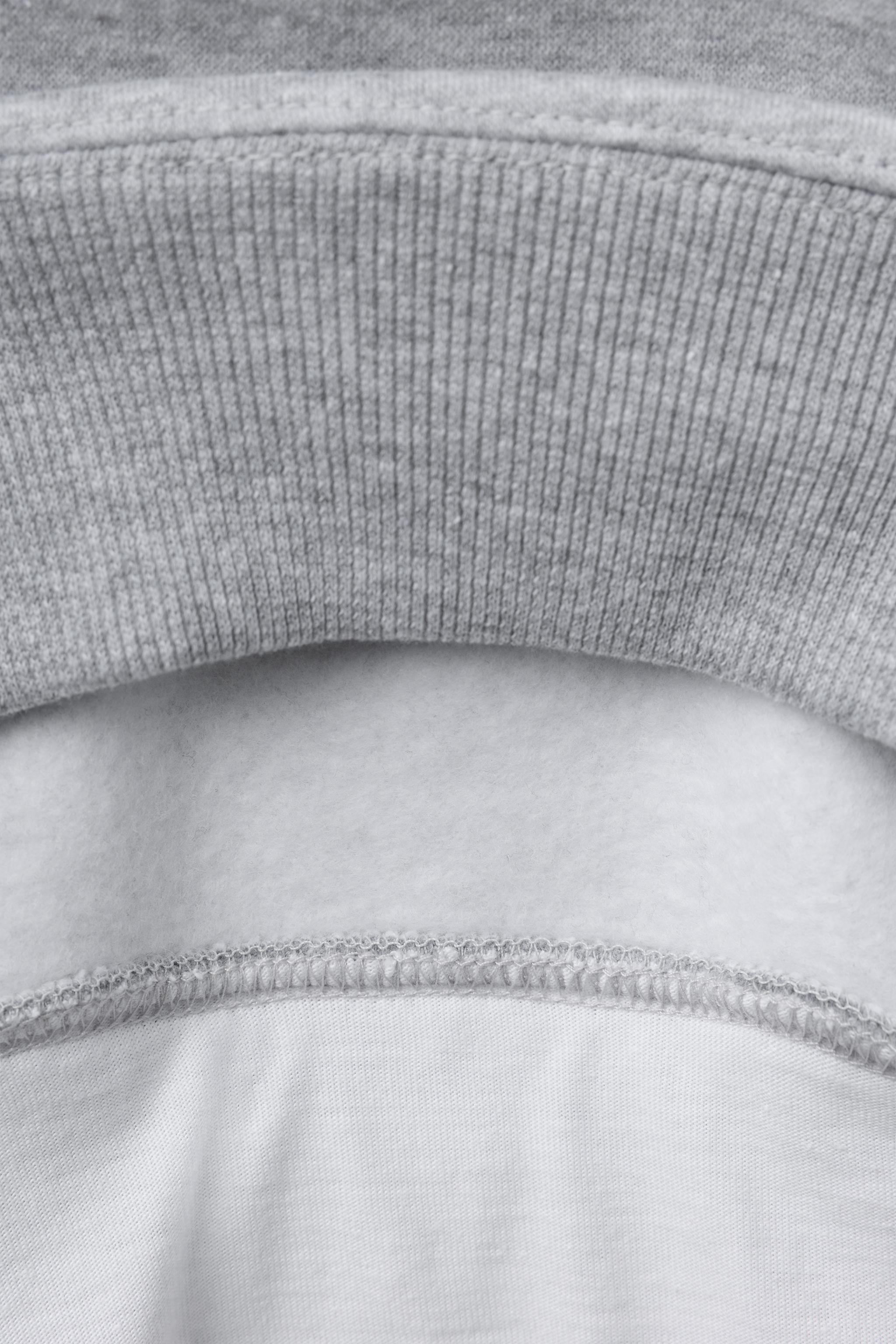 VARSITY DOUBLE HEM HOODED SWEATSHIRT