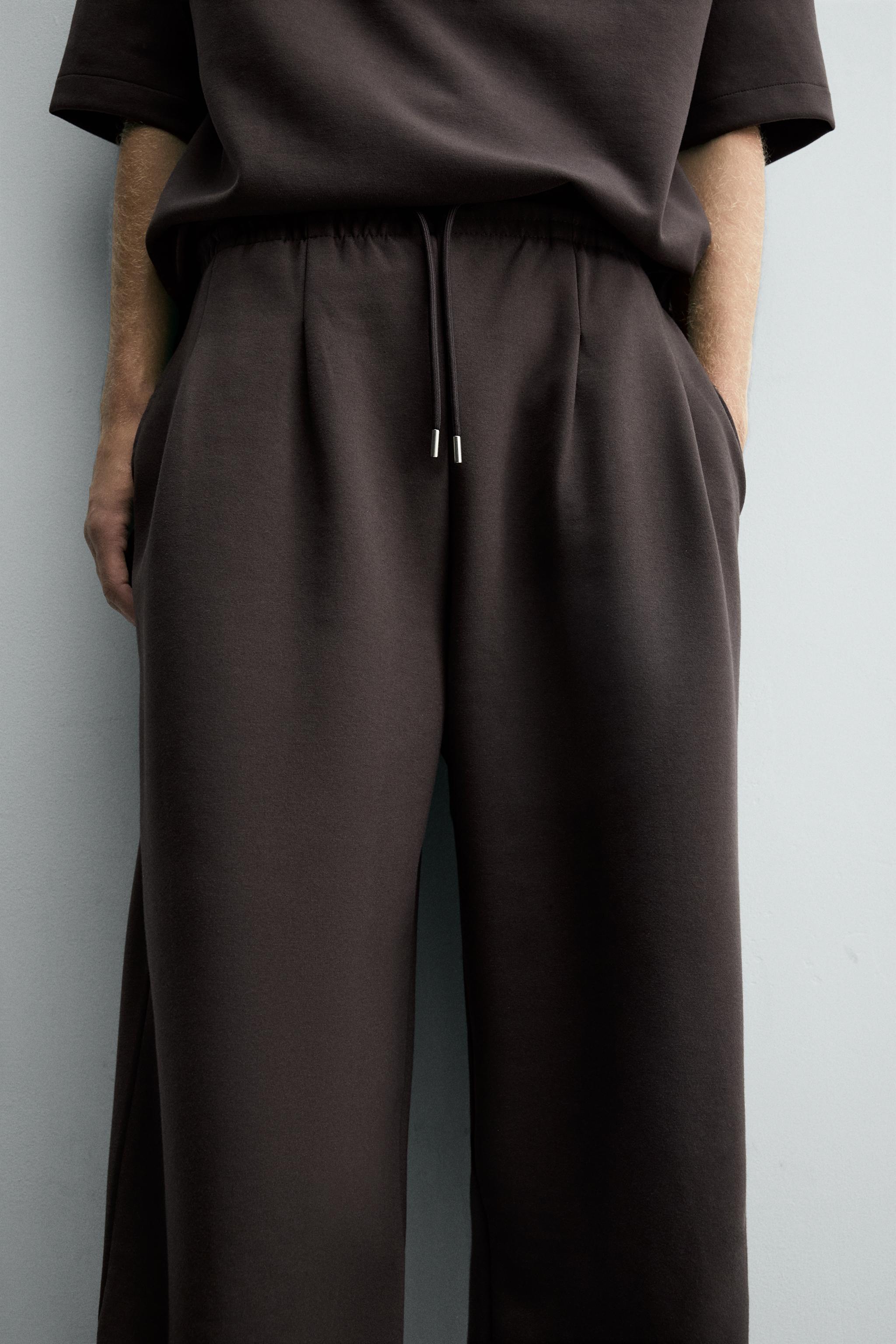 INTERLOCK PLEATED LABEL PANTS