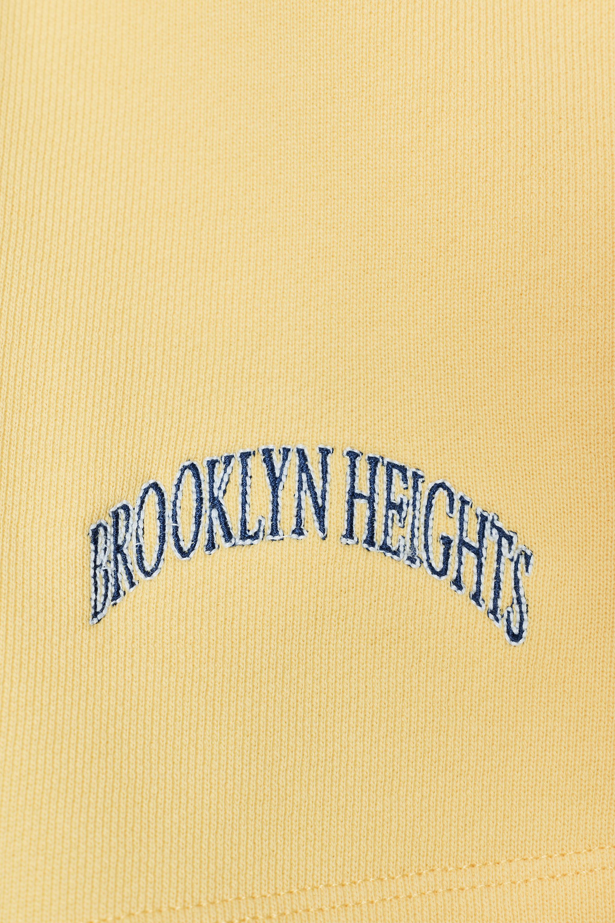 EMBROIDERED TEXT FLEECE SHORTS