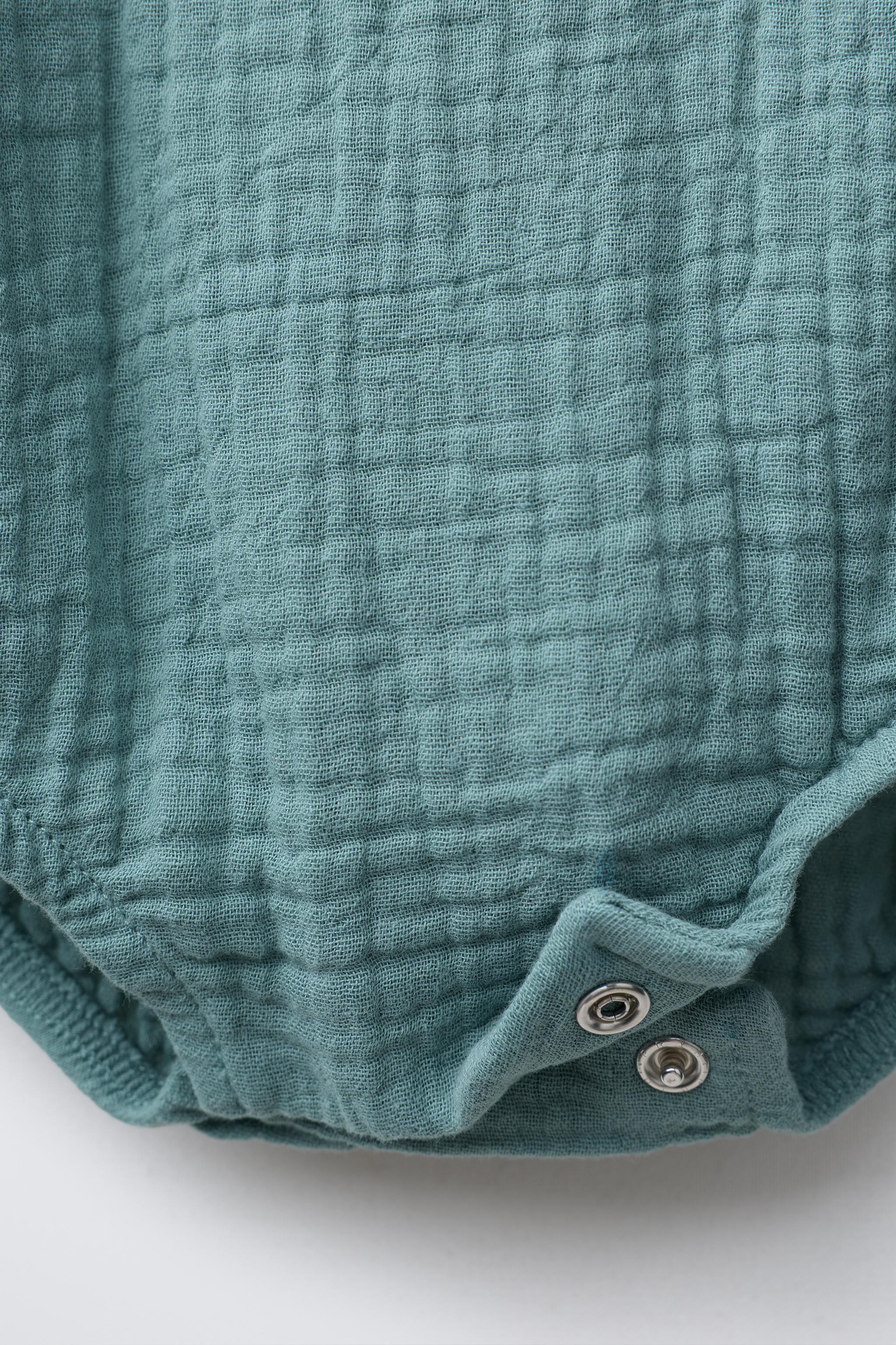 TEXTURED JUMPSUIT WITH ELEPHANT EMBROIDERY