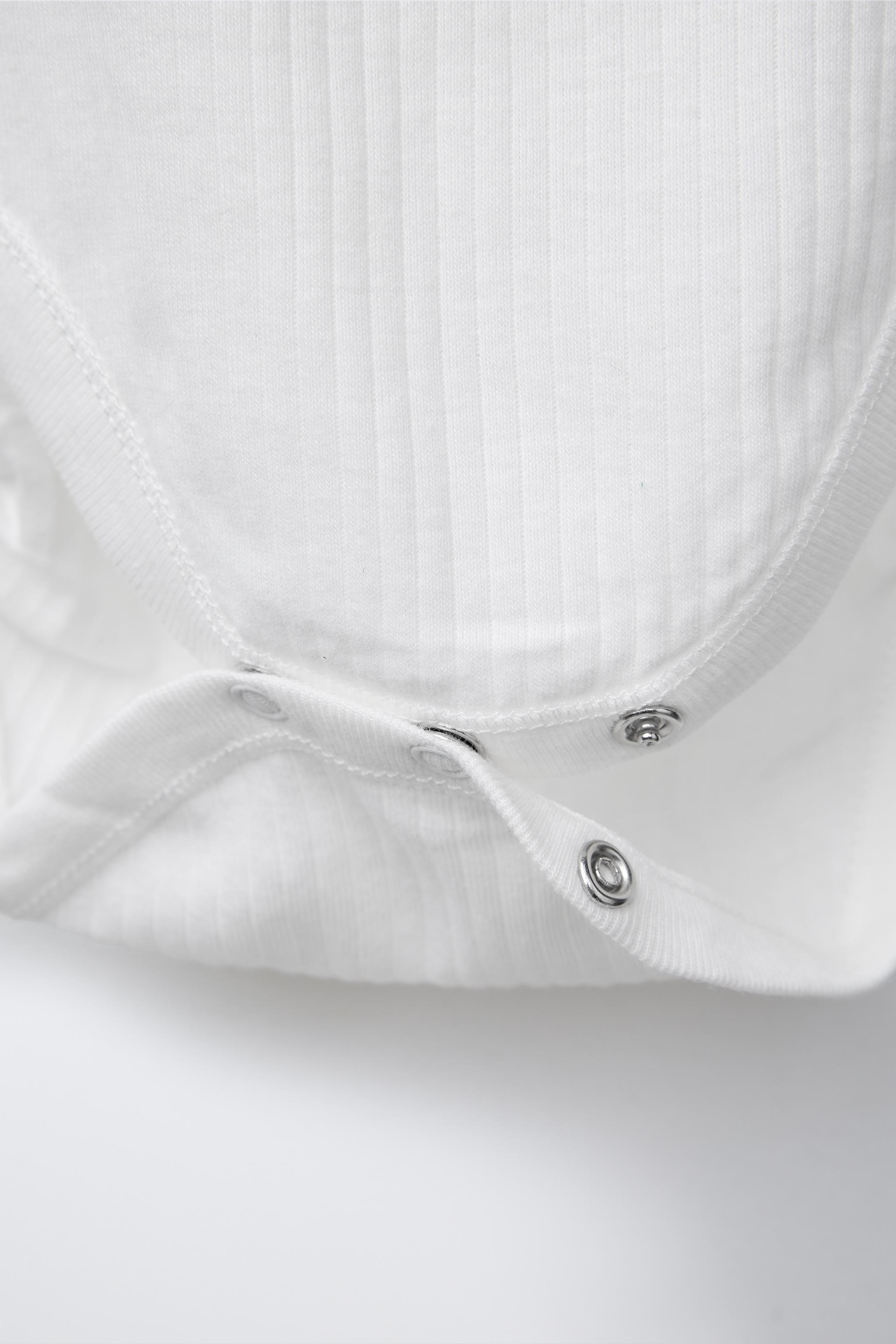 THREE-PACK OF RIBBED SLEEVELESS BODYSUITS