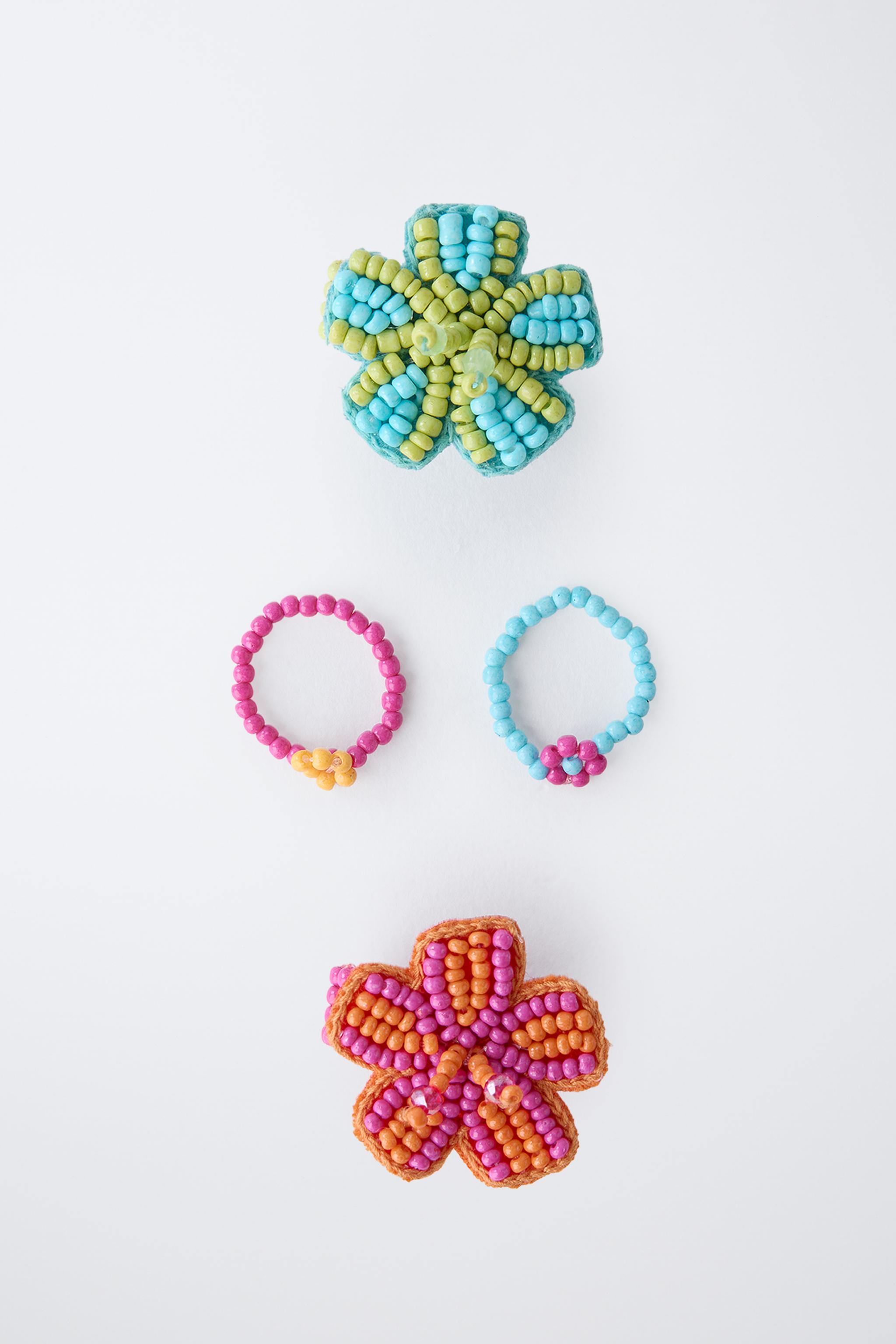 FOUR-PACK OF BEADED FLOWER RINGS