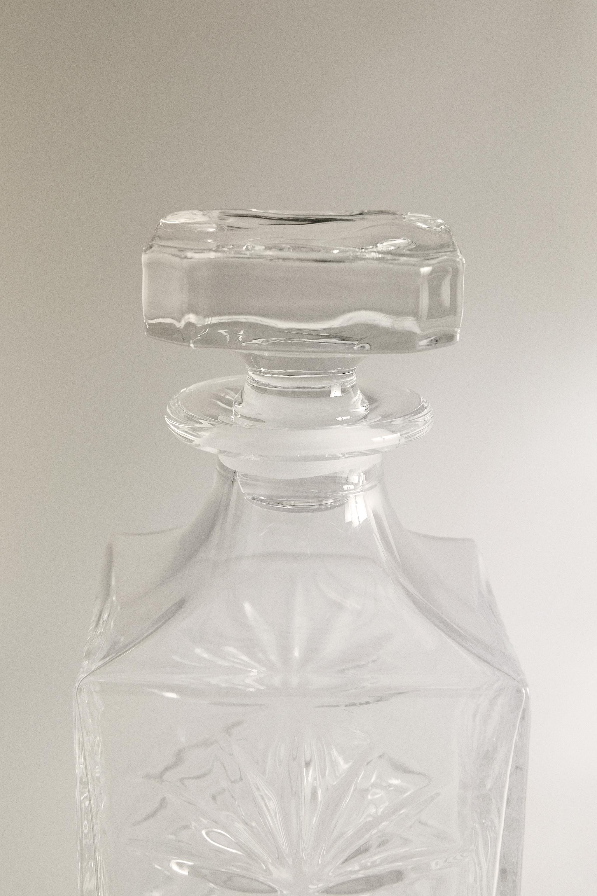 CRYSTALLINE BOTTLE WITH RAISED DESIGN