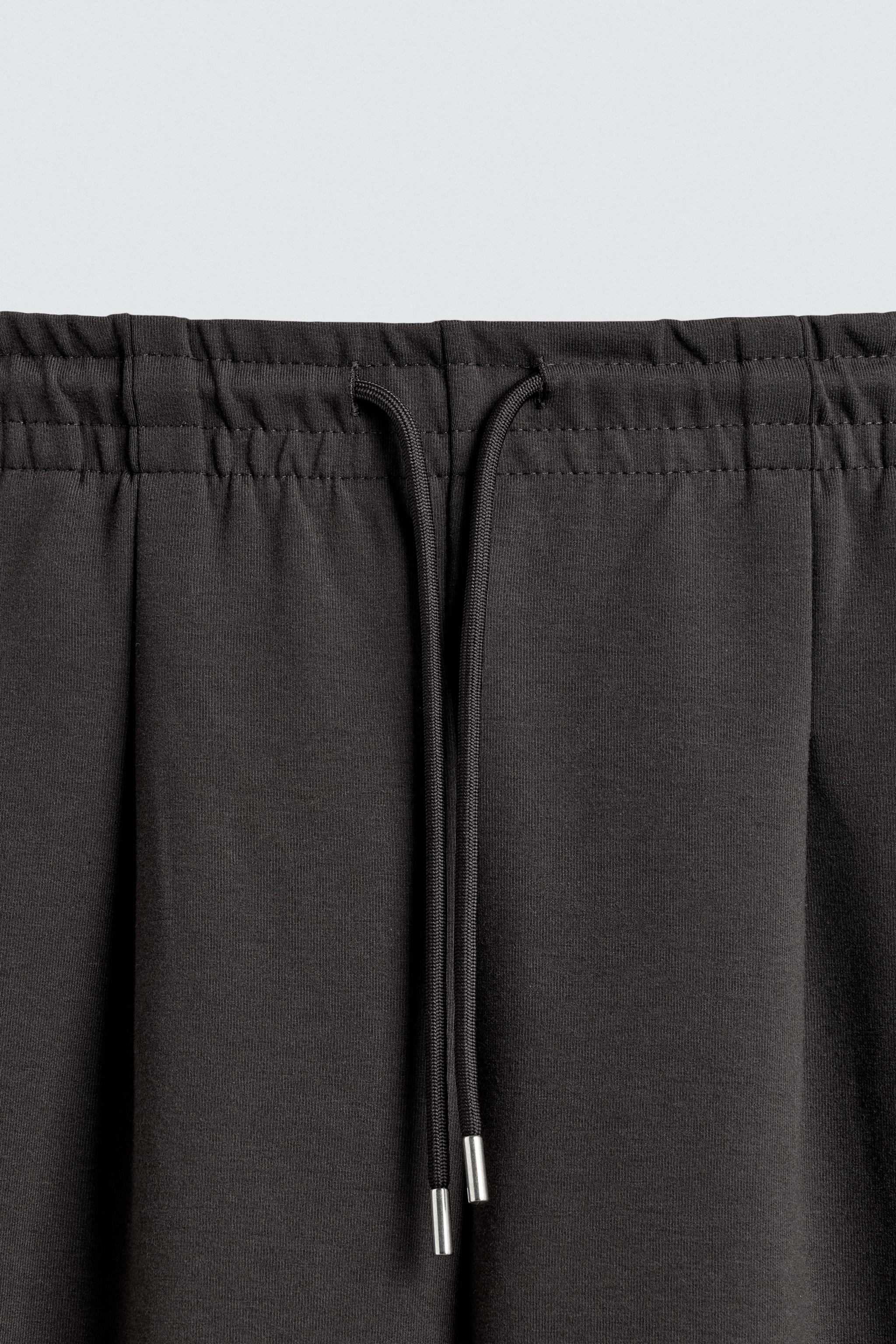 INTERLOCK PLEATED LABEL PANTS