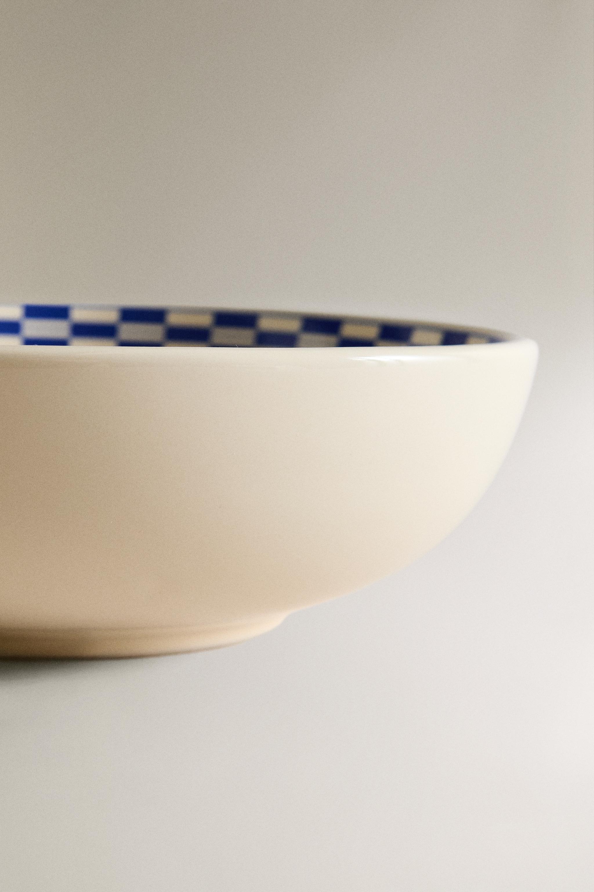 CERAMIC BOWL WITH A CHECKED DESIGN ON THE RIM