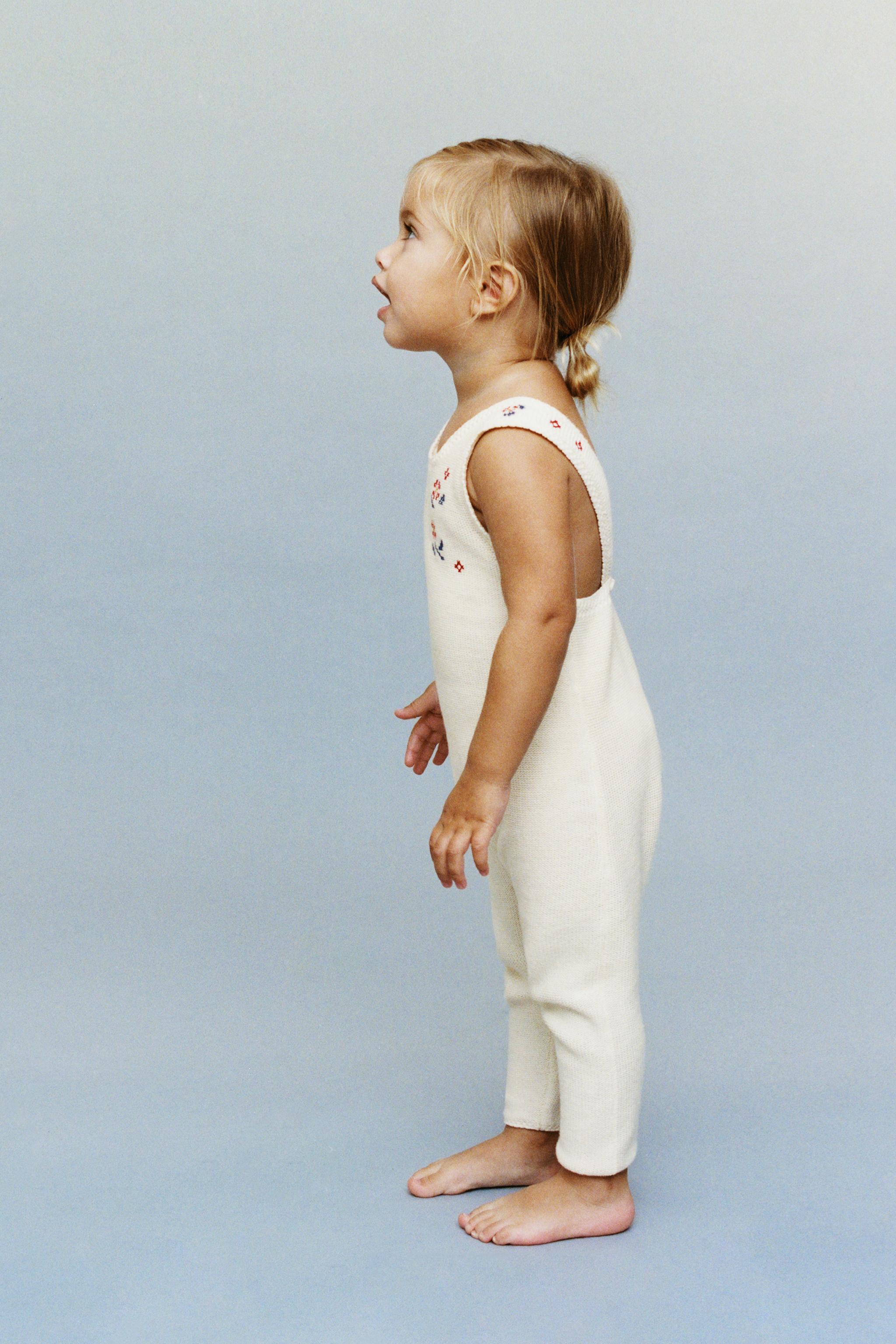 LONG KNIT OVERALLS WITH CROSS-STITCH DETAILS