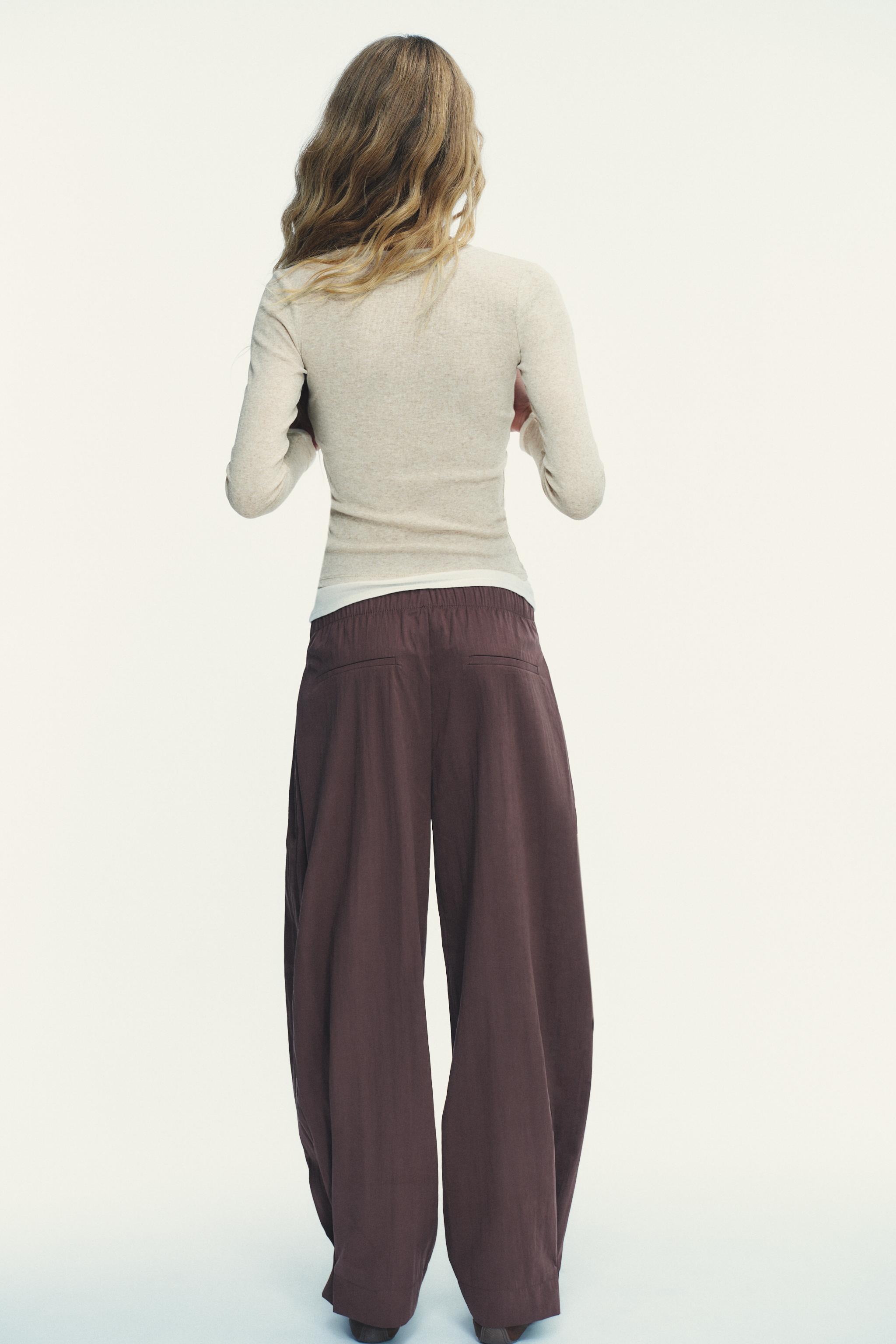 NYLON PANTS WITH BUTTON HEM