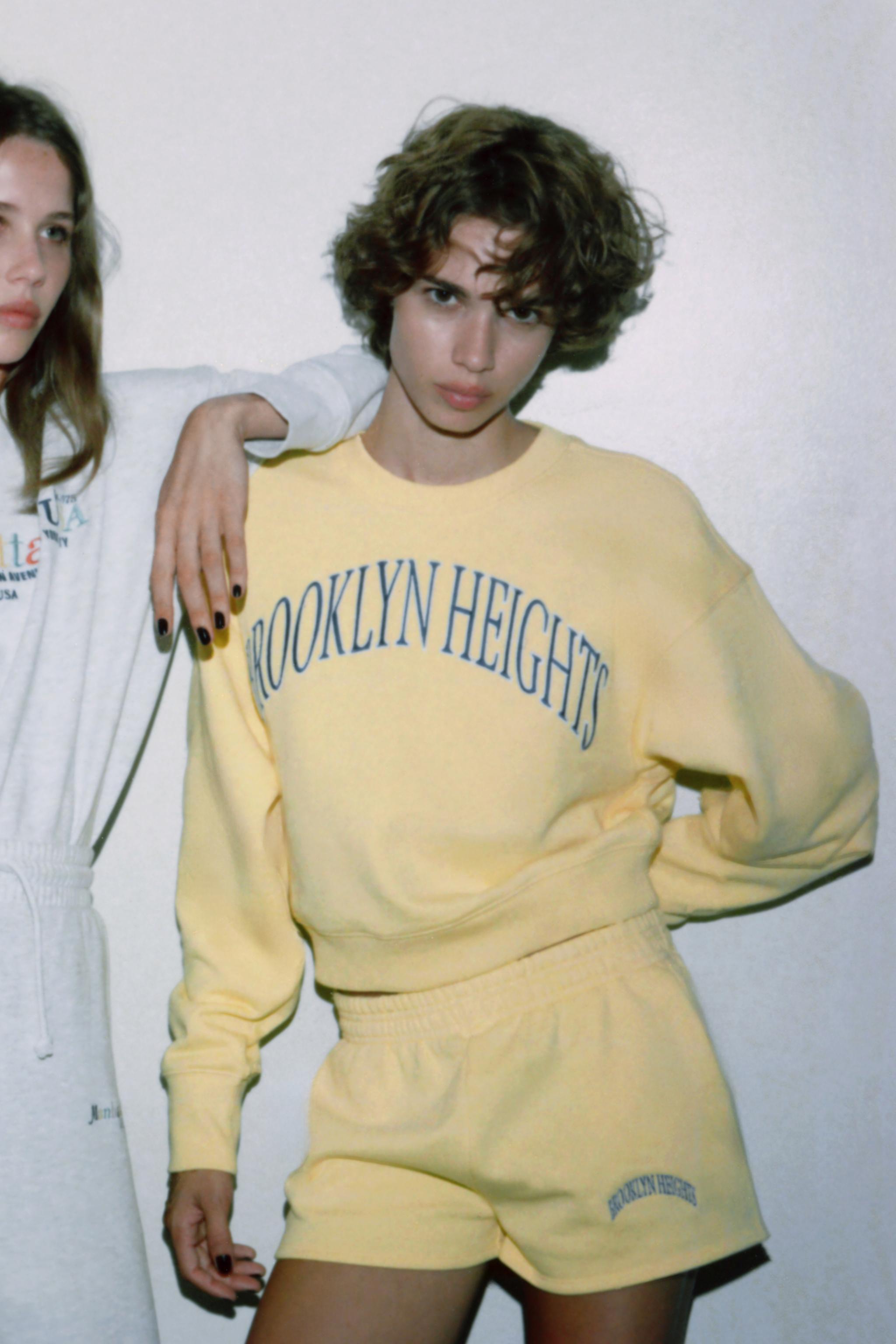 EMBROIDERED TEXT FLEECE SHORTS