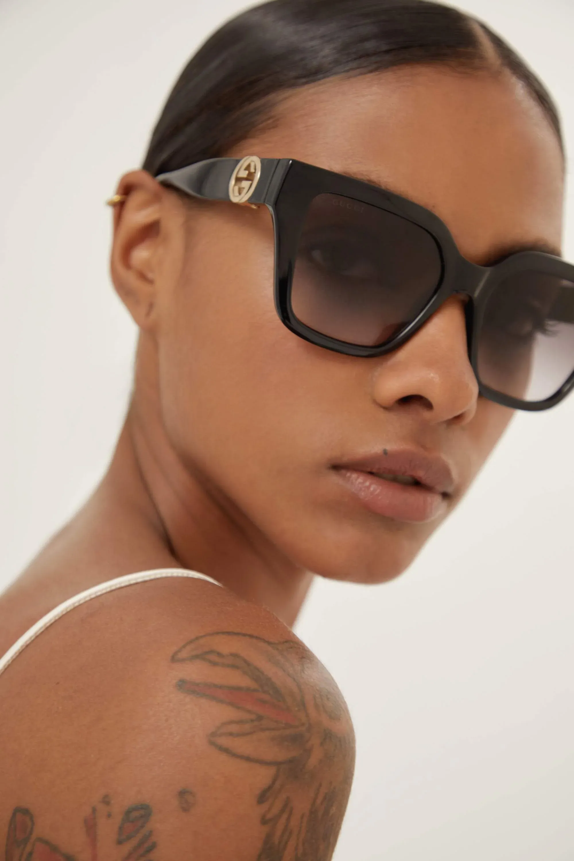 Gucci cat-eye black sunglasses with integrated GG logo