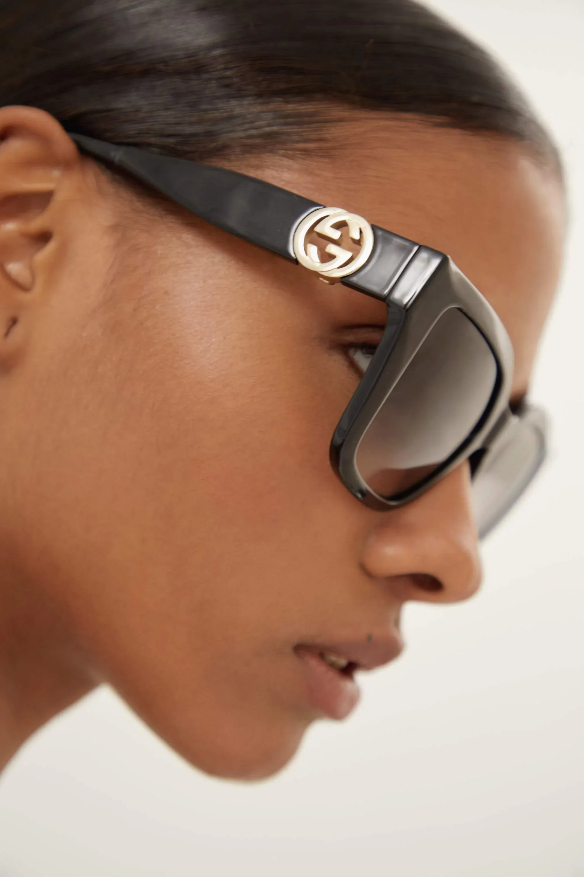 Gucci cat-eye black sunglasses with integrated GG logo