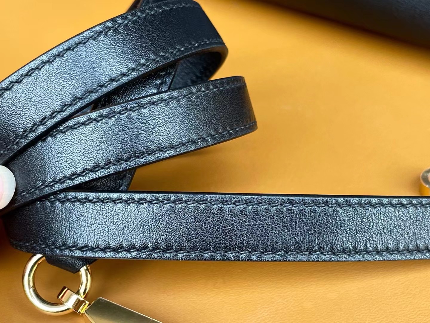 Kelly32 black gold swift leather