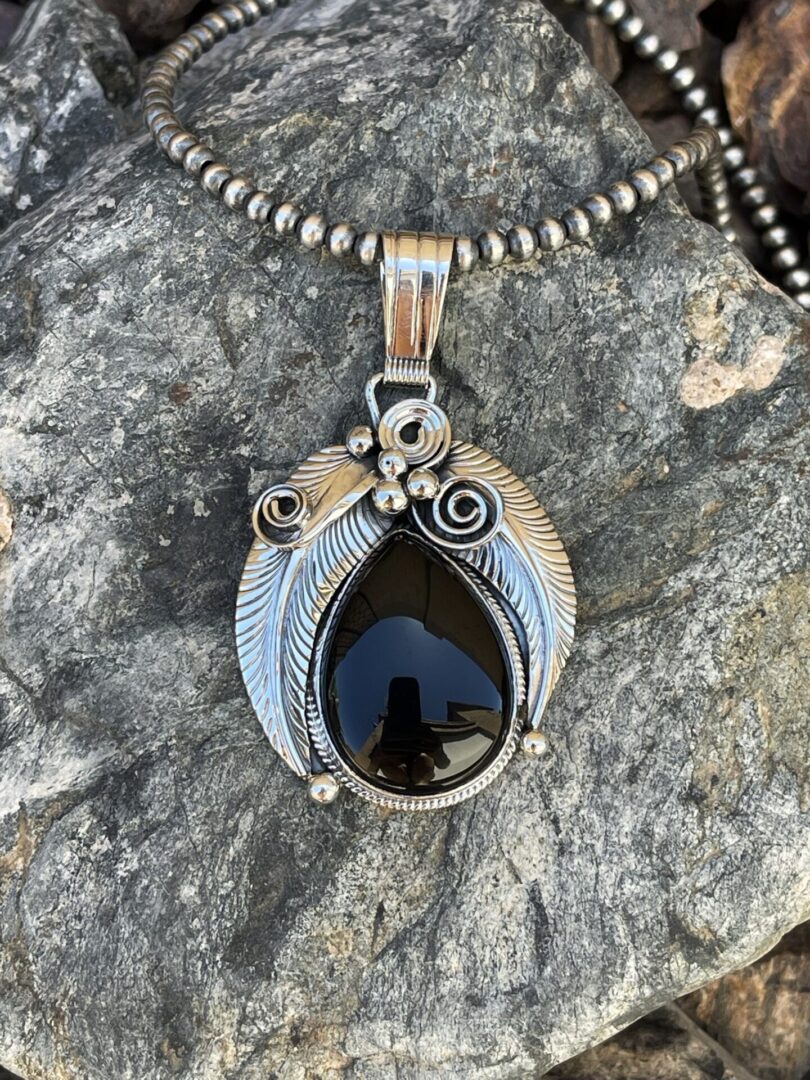 Sterling Silver Black Onyx Pendant with Feather, Scroll and Bead Detail