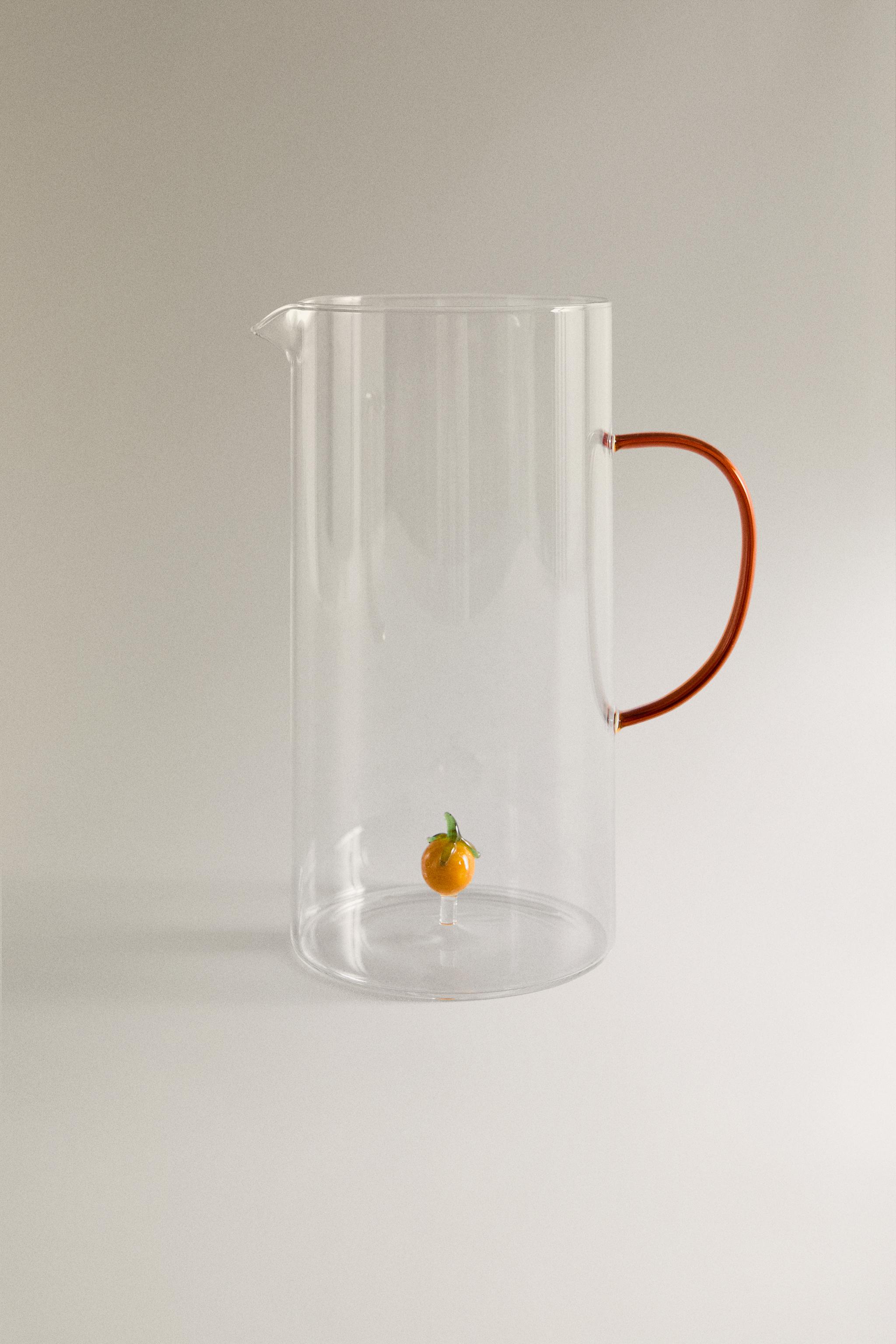 GLASS PITCHER WITH A HANDLE AND ORANGE DETAIL