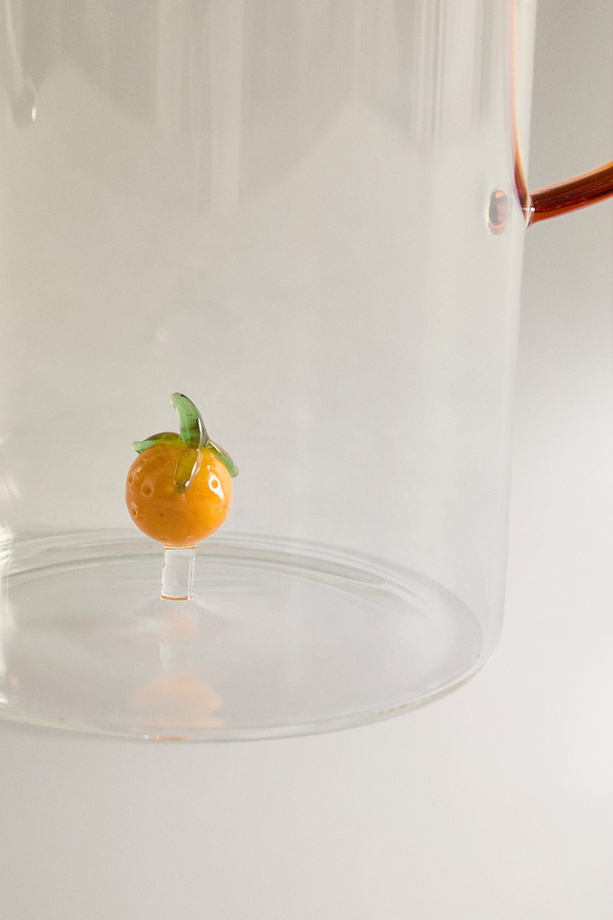 GLASS PITCHER WITH A HANDLE AND ORANGE DETAIL