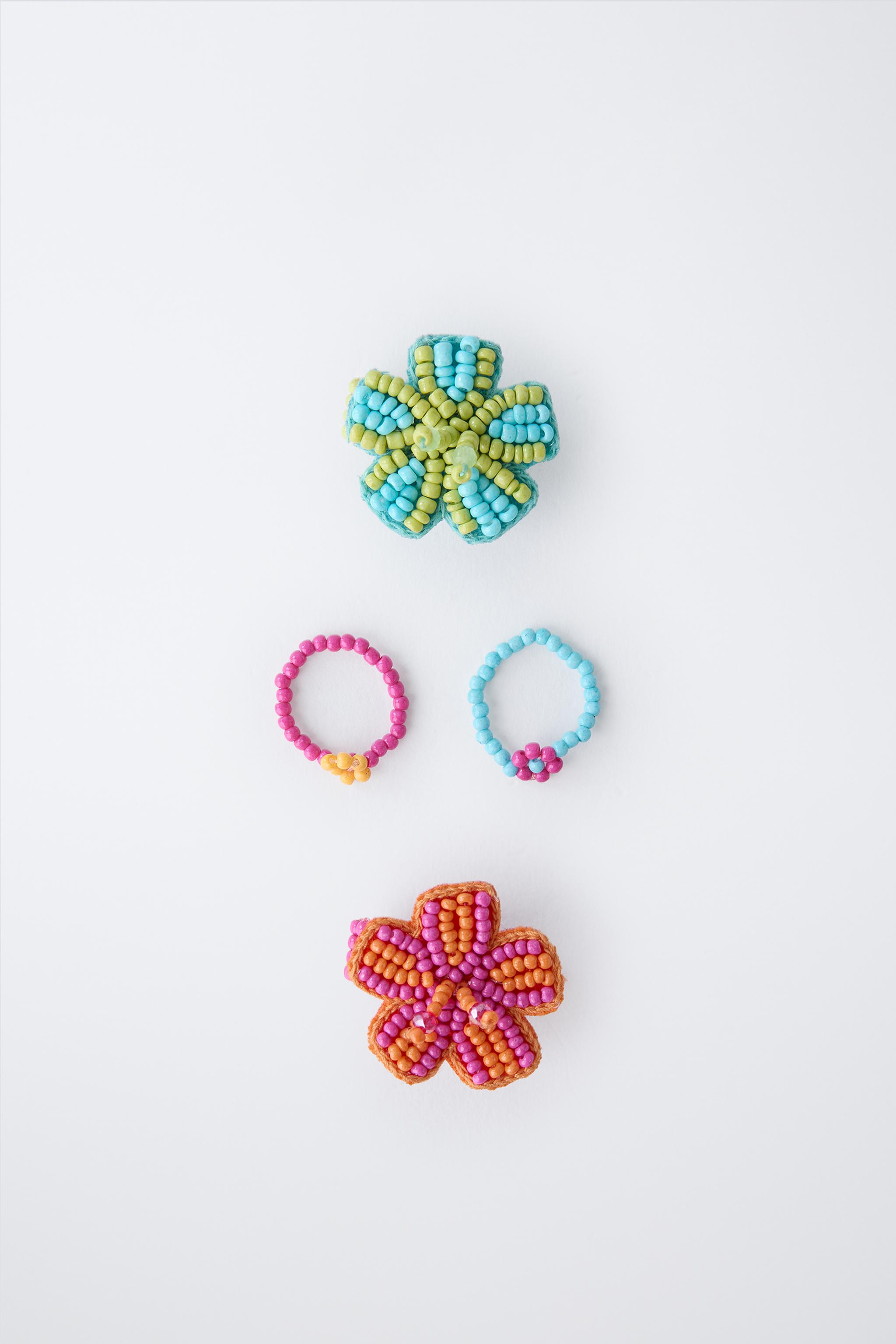 FOUR-PACK OF BEADED FLOWER RINGS