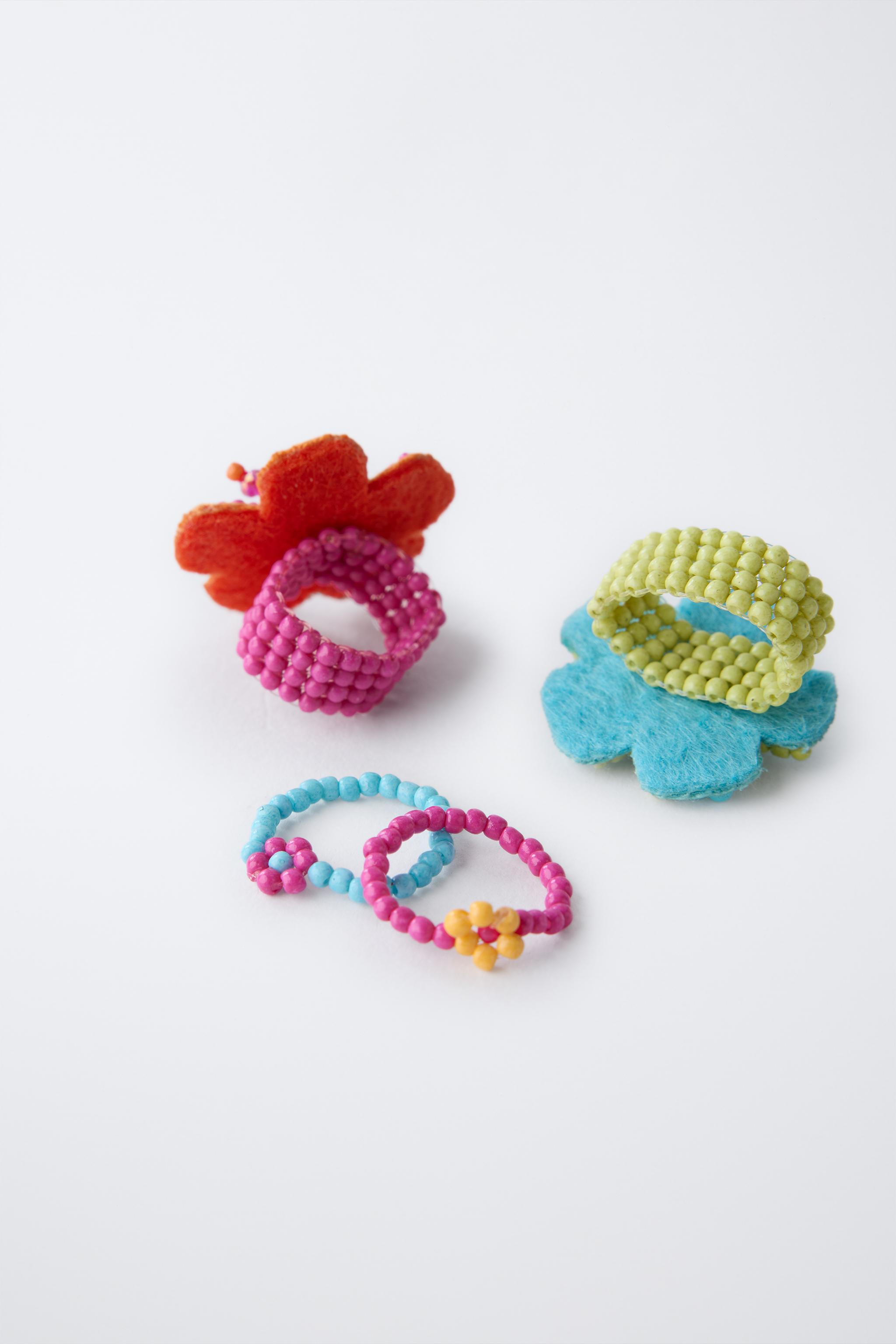 FOUR-PACK OF BEADED FLOWER RINGS