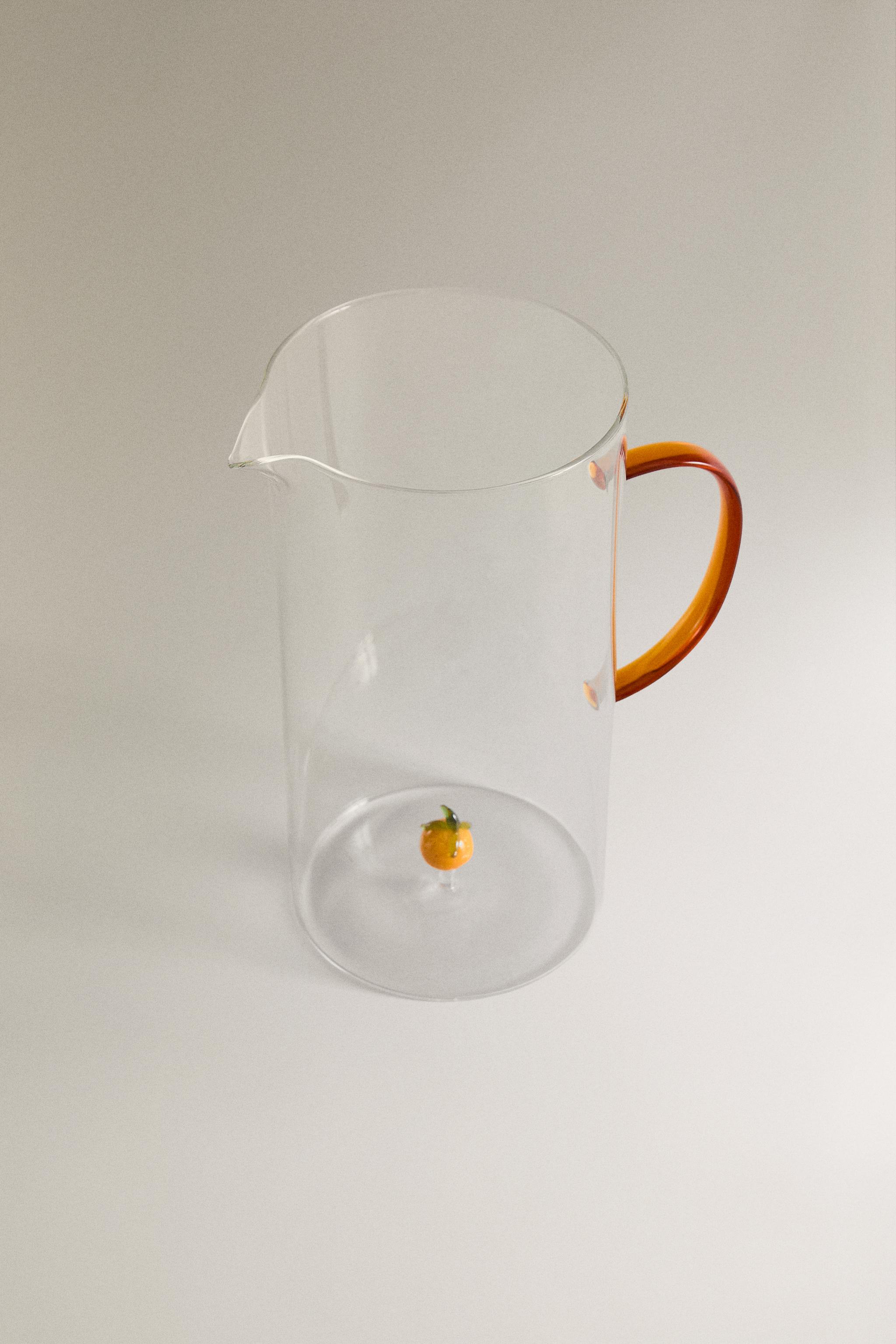 GLASS PITCHER WITH A HANDLE AND ORANGE DETAIL